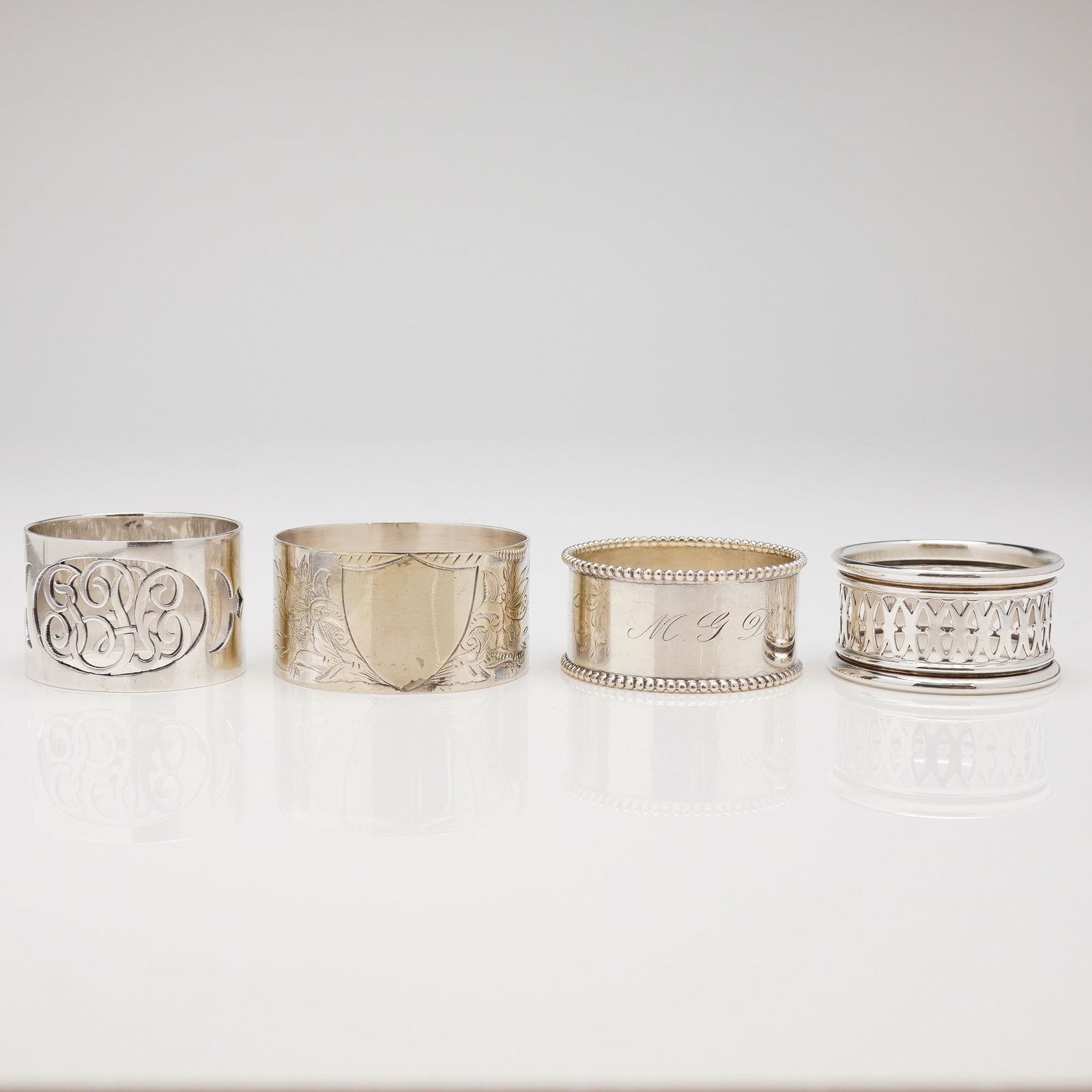 A Collection of Four Assorted Sterling Silver Napkin Rings (1 of 5)