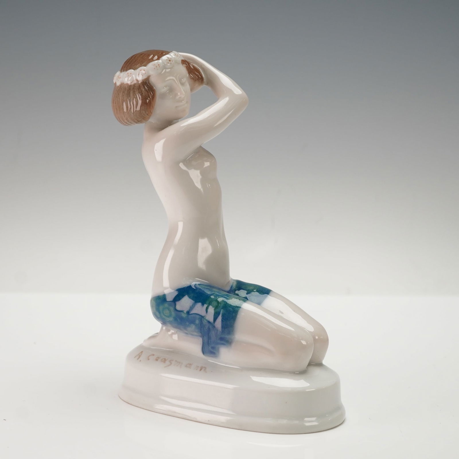 Rosenthal Art Deco Porcelain Figurine Ariadne by Albert Caasmann: A Rosenthal Art Deco porcelain figurine, Ariadne, designed by Albert Caasmann (1886-1968). This glazed porcelain figurine depicts a kneeling female figure with short, reddish-brown hair adorned with a