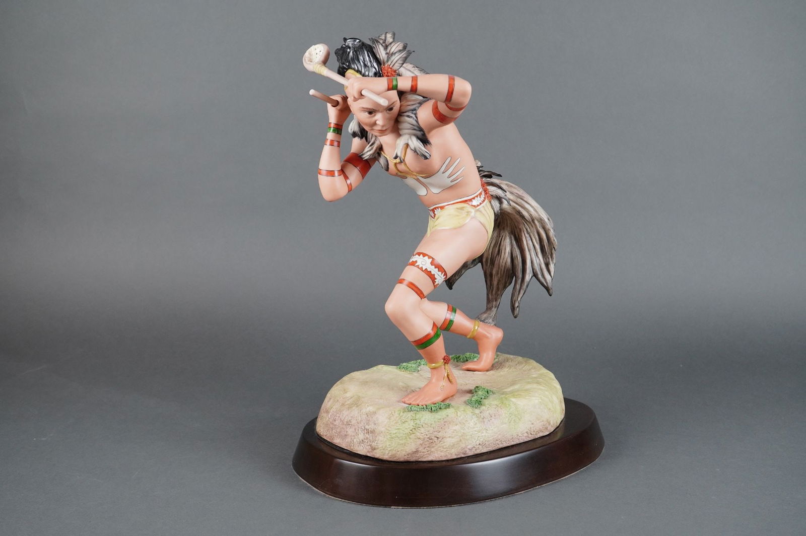 Cybis Porcelain Choctaw Tascalusa Lacrosse Player Sculpture: A single polychrome figural sculpture identified through market consensus as the Cybis Choctaw Tascalusa Lacrosse Player. This indigenous warrior sculpture is executed in matte porcelain or cold-cast