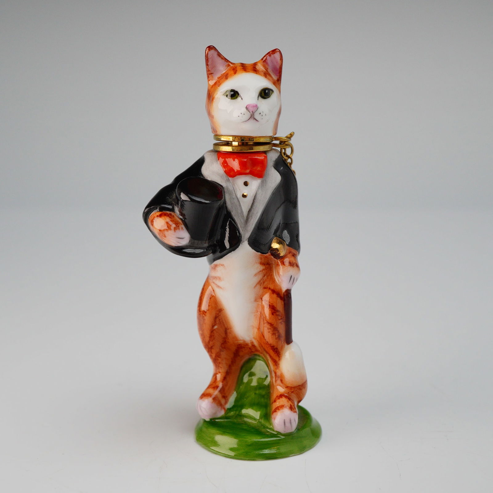 Royale Stratford Hand-Painted Gentleman Cat Trinket Box: A single hand-painted porcelain trinket box, identified as a Royale Stratford Gentleman Cat Figurine, sometimes referred to as a snuff bottle due to its hinged construction. The anthropomorphic cat is