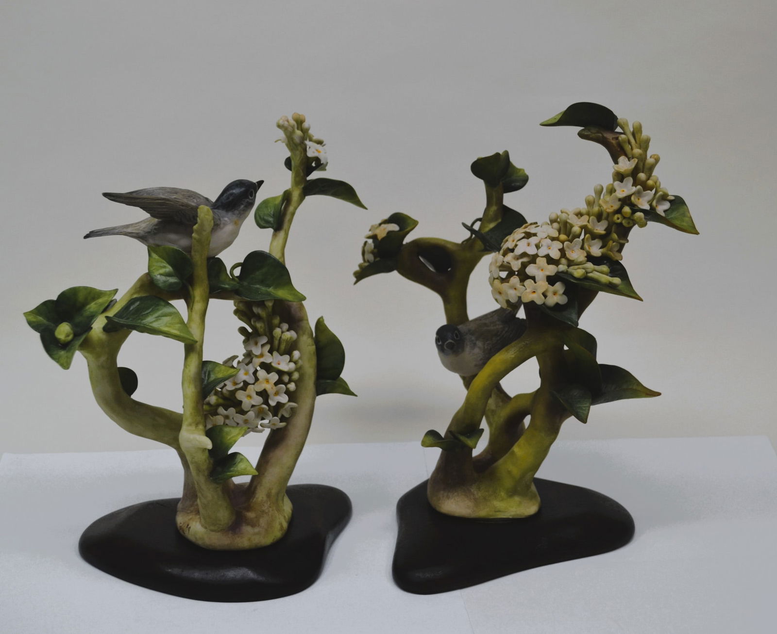 2 Cybis Porcelain Blue Headed Verios w/ Lilac Sculptures, 1967: Bisque Porcelain Decorated, hand created, hand painted by the Artisans of the Cybis Studio in Trenton, New Jersey, USA. Featuring The Blue Headed Verios with Lilac, Pair, a Limited Edition of 275, ear