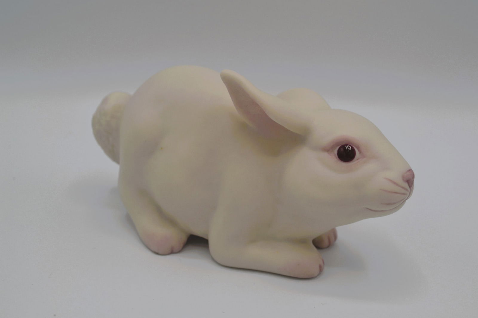 Cybis Porcelain 50th Anniversary Bunny Sculpture, 1989: Bisque Porcelain Decorated, hand created, hand painted by the Artisans of the Cybis Studios in Trenton, NJ, USA. Featuring the 50th Anniversary Bunny, Hand Decorated, in Natural with Pastel Pink accen