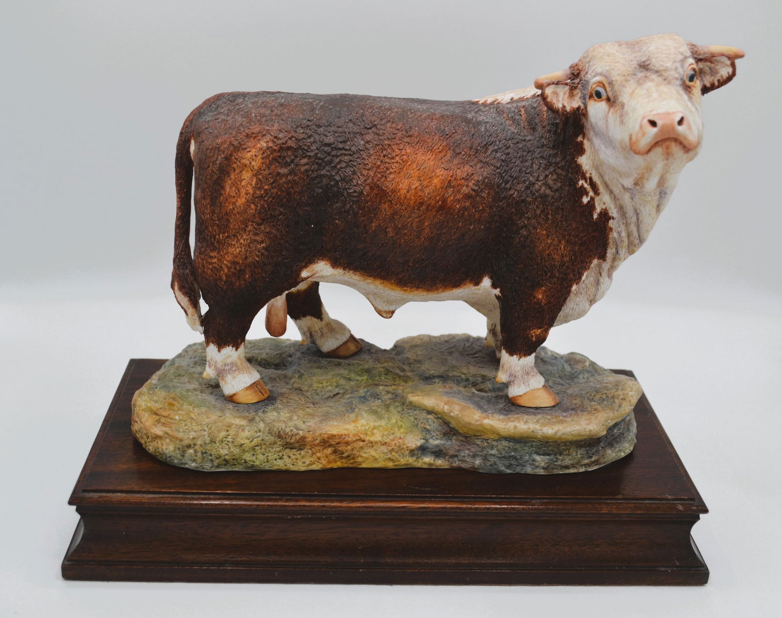 Hereford China, Ltd., UK, Porcelain Hereford Bull With Wood Base, 1977: Fine Bone China, Decorated, hand created, hand painted by the Artists of the Hereford China, Ltd., Studios in England, UK. Featuring the Hereford Bull, Standing. Excellent detail, hand decorated in fu