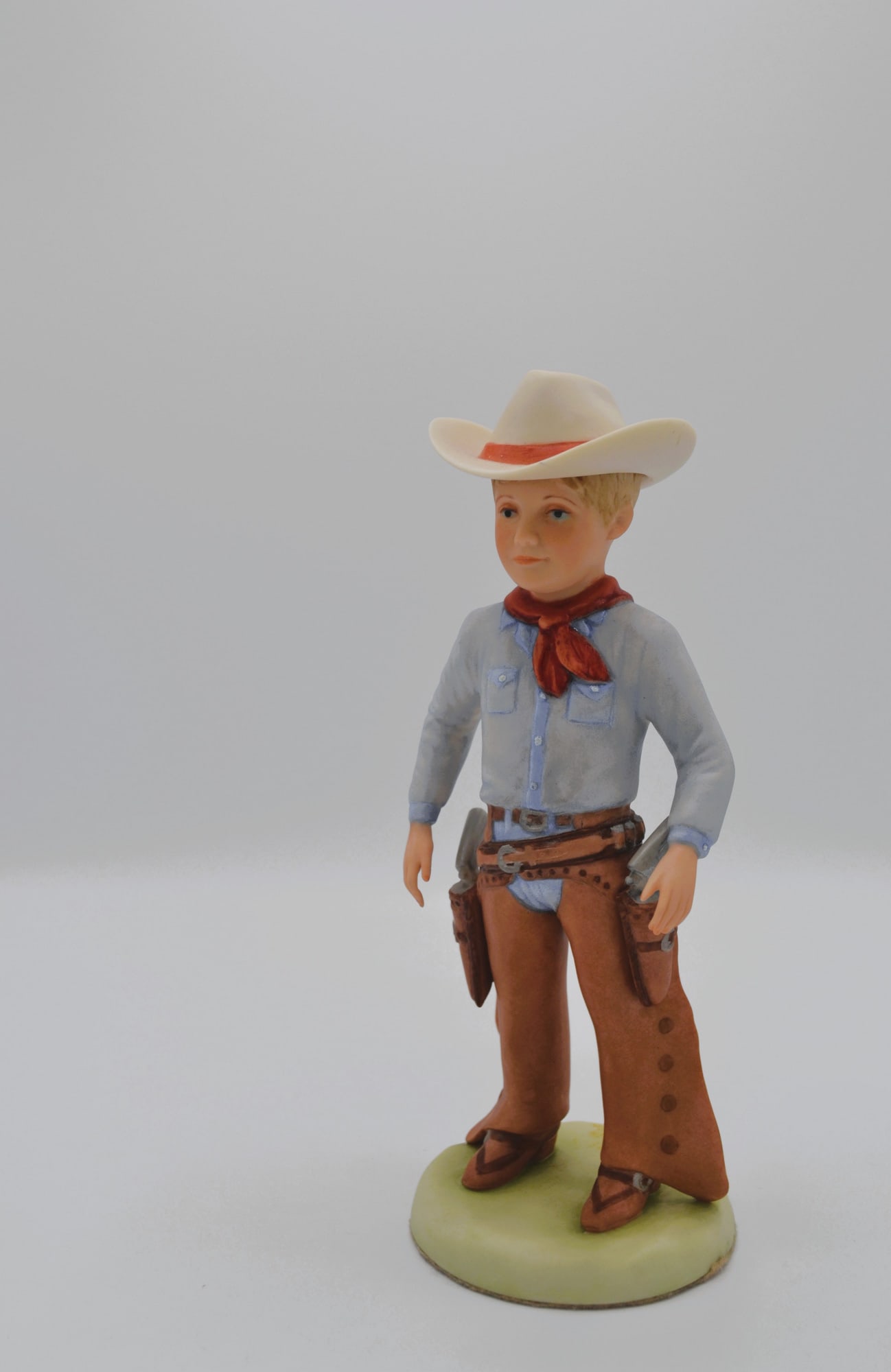 Cybis Porcelain Cowboy Little Boy Sculpture, Vintage: Bisque Porcelain Decorated, hand created, hand painted by the Artisans of the Cybis Studio in Trenton, NJ, USA. Featuring the Sculpture of the "Little Boy Cowboy" from the Children to Cherish Collecti