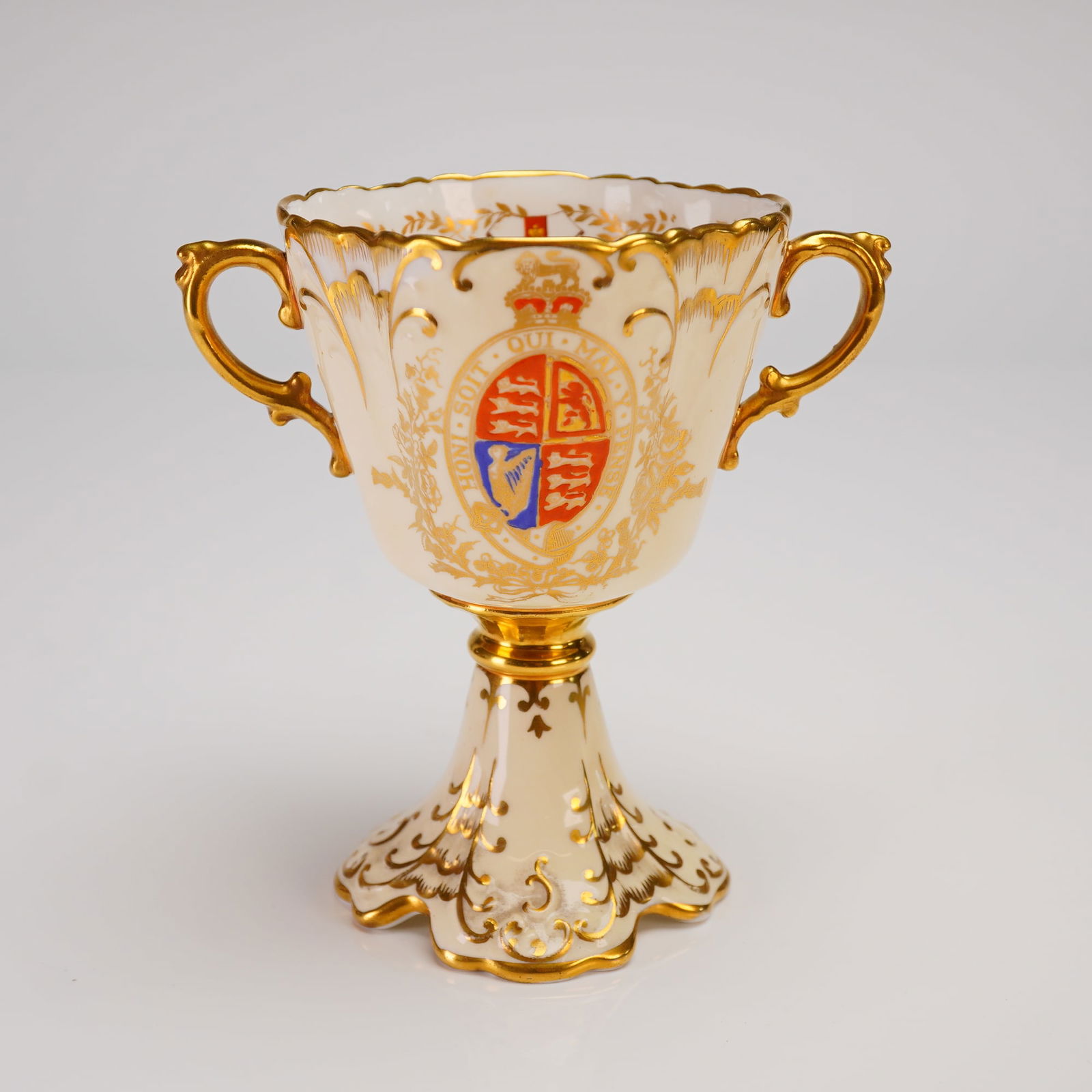 Aynsley Bone China Commemorative George VI Loving Cup: A single Aynsley porcelain commemorative cup, crafted from bone china, designed as a miniature loving cup. The piece celebrates the Coronation of King George VI in 1937. The creamy white ground is ext