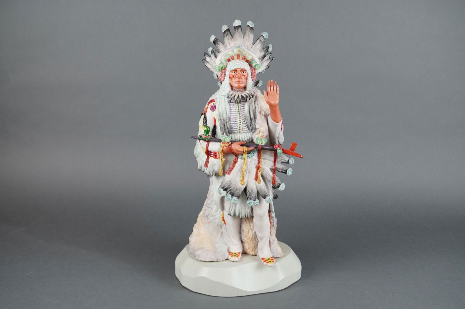 Cybis Porcelain Sculpture Wankan Tanka The Great Spirit Sioux Chief: A large, hand-painted porcelain figural sculpture by Cybis, titled "Wankan Tanka" (The Great Spirit), depicting a Sioux Indian Chief. This detailed Cybis Indian Chief Sculpture shows the figure standi