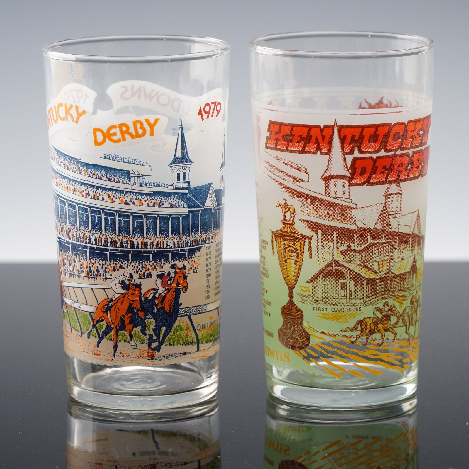 2pc Collectible Kentucky Derby Highball Glasses 1978 & 1979: Two collectible Kentucky Derby highball glasses from 1978 and 1979, each featuring vibrant graphics of Churchill Downs, racing thoroughbreds, and the iconic twin spires. These glasses showcase detaile