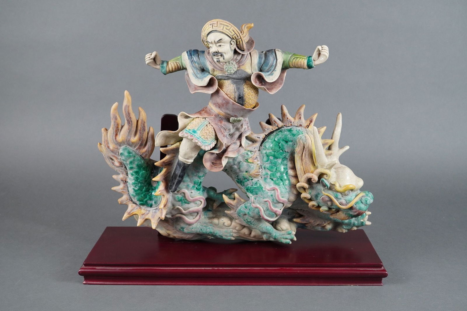 Chinese Koji Ware Style Polychrome Glazed Earthenware Roof Tile Sculpture: Attributed to the Koji Ware School, Late Qing/Early Republic Period (19th/early 20th Century). This Asian Roof Tile Sculpture depicts a dynamic warrior or deity figure, possibly a Daoist immortal, sta