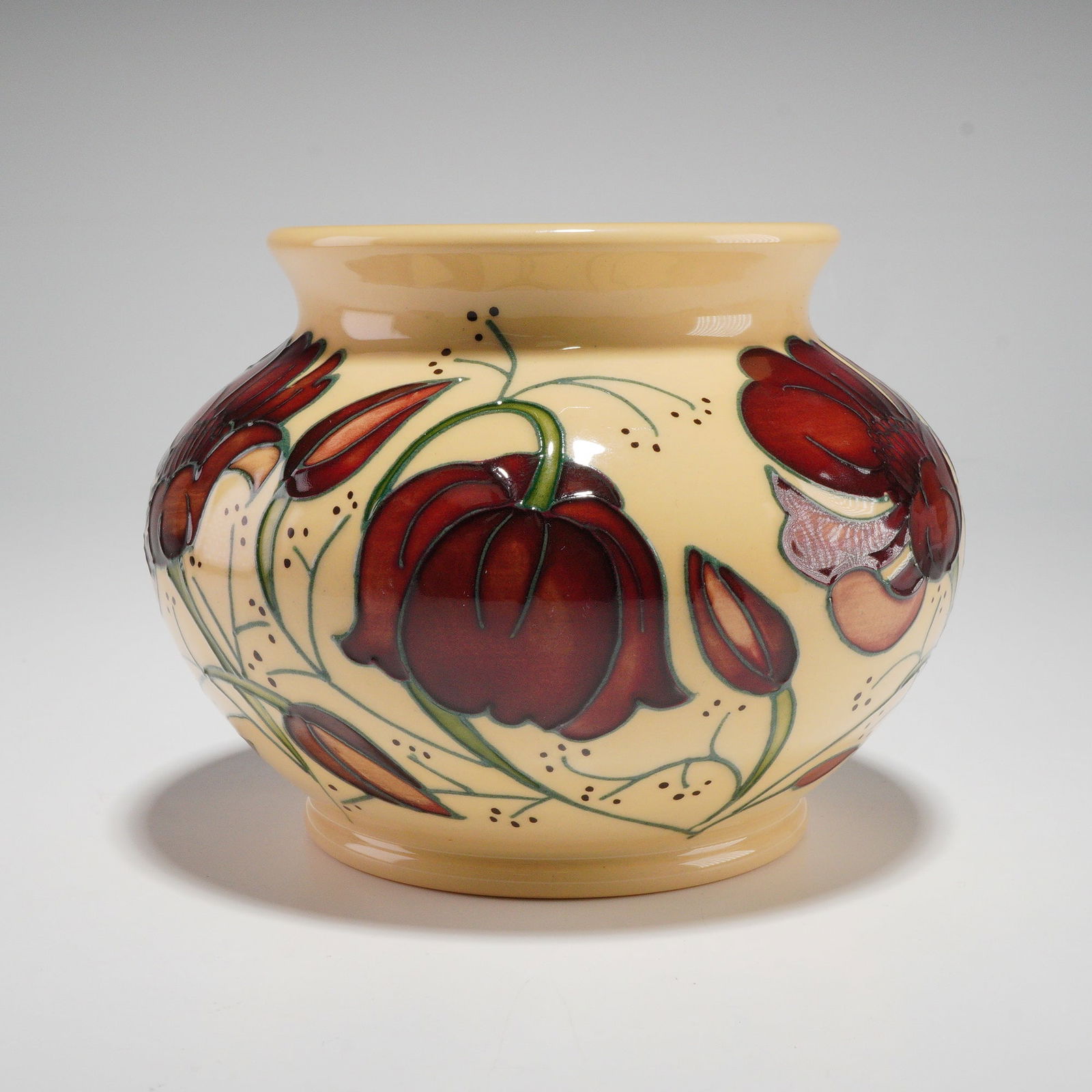 Moorcroft by Rachel Bishop Pottery Vase, Chocolate Cosmos: A Moorcroft Chocolate Cosmos vase designed by Rachel Bishop featuring rich, velvety red cosmos blossoms with subtle tonal shading set against a warm cream ground, each flower outlined in the tube-lini