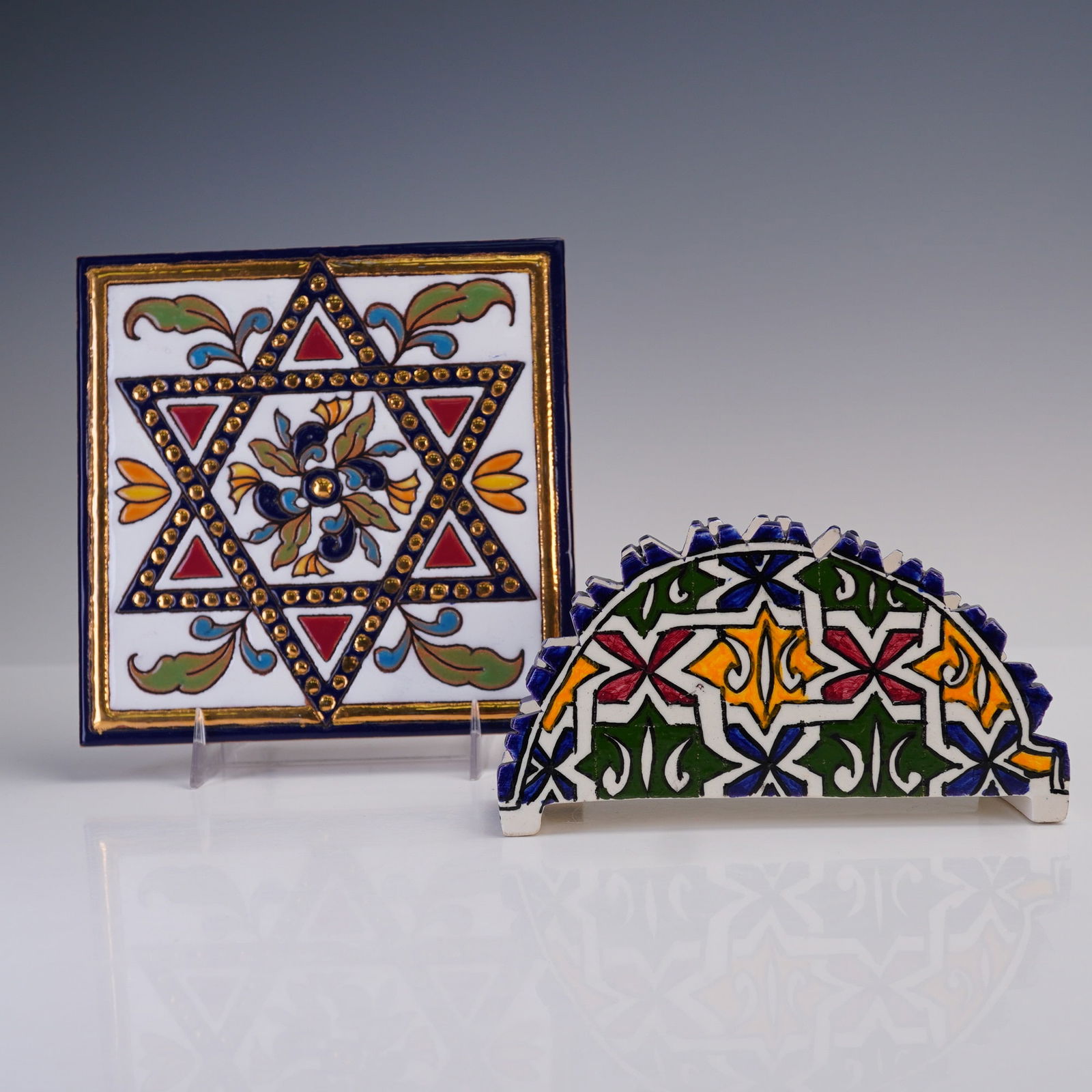 2pc Hand-Painted Ceramic Judaica & Moorish-Style Decorative Tiles: A charming pair of brightly glazed, hand-painted ceramic pieces, combining vibrant cultural motifs and traditional craftsmanship: The first is a square wall plaque tile featuring a bold Star of David