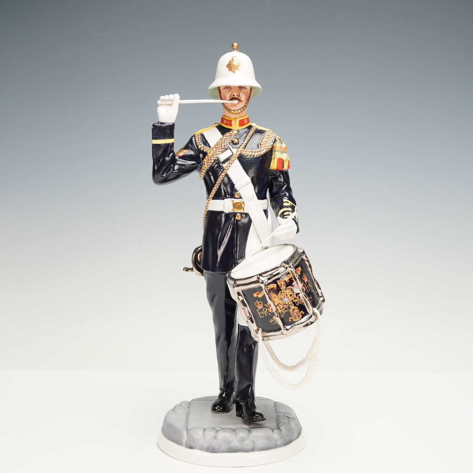 Michael Sutty Porcelain Sculpture, Bugler, Royal Marines 1989: Limited edition hand modeled and hand painted military figurine featuring a bugler with an intricate design of drum, who led the Royal Marines Band Service, highly trained on both the side drum and th