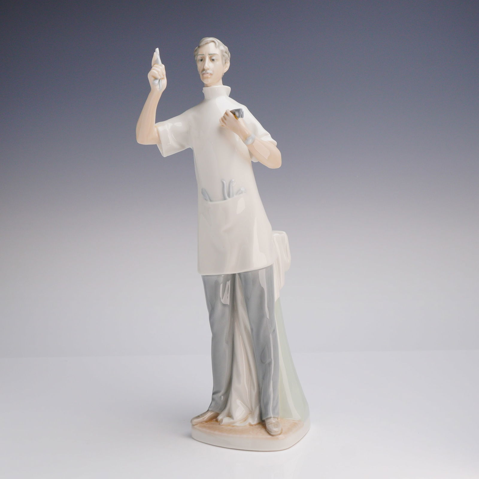 Lladro Porcelain Figurine, Dentist 1004762: Figurine of a bundled child standing beside a small polar bear, finished in glossy pastel tones. Lladro backstamp on the underside. Artist: Juan Huerta Issued: 1984-2017 Dimensions: 2.5"L x 2.5"W x 5.
