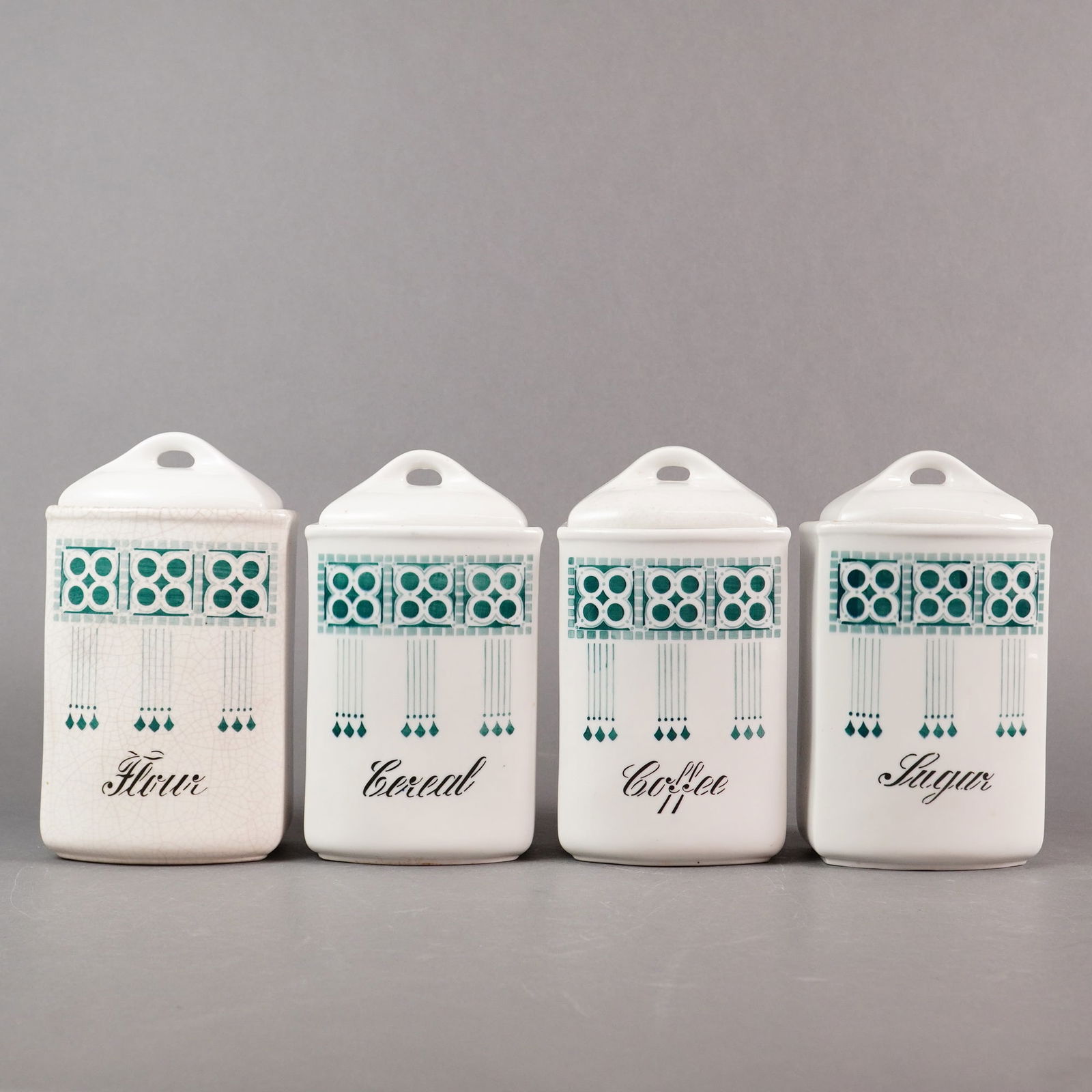 Collection of Four German Ceramic Wall Mount Kitchen Canisters: A pair of antique ceramic food molds, commonly referred to as Yellow Ware or Treacleware, suitable for baking, pudding, or jello preparations. The 2pc set is formed from buff earthenware and covered i