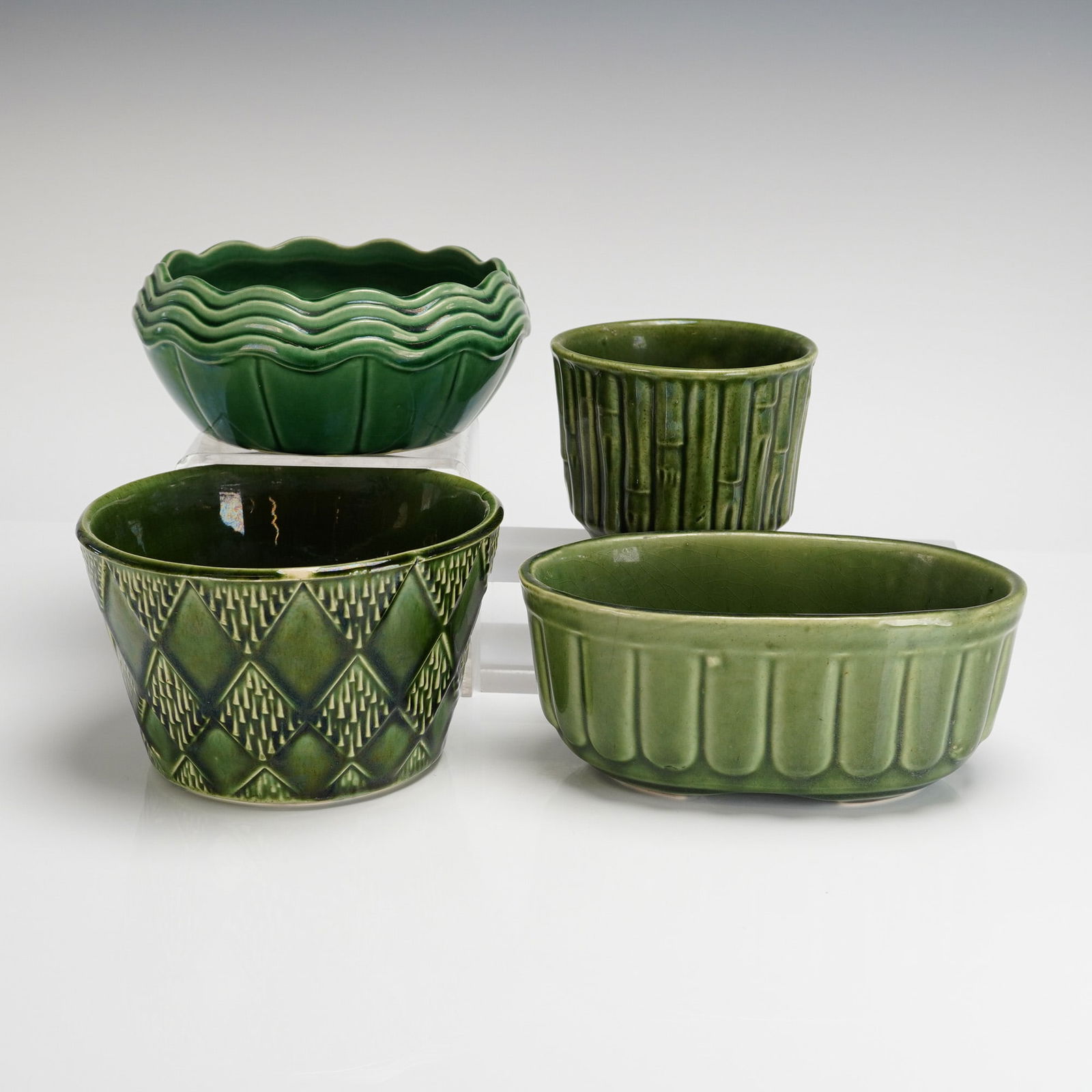 4 Mid-Century Green Ceramic Planters, McCoy & Brush Pottery: A collection of four Mid-Century American ceramic vessels, likely planters or containers, finished in varying shades of glossy green glaze. The grouping includes pieces attributed to McCoy Pottery and