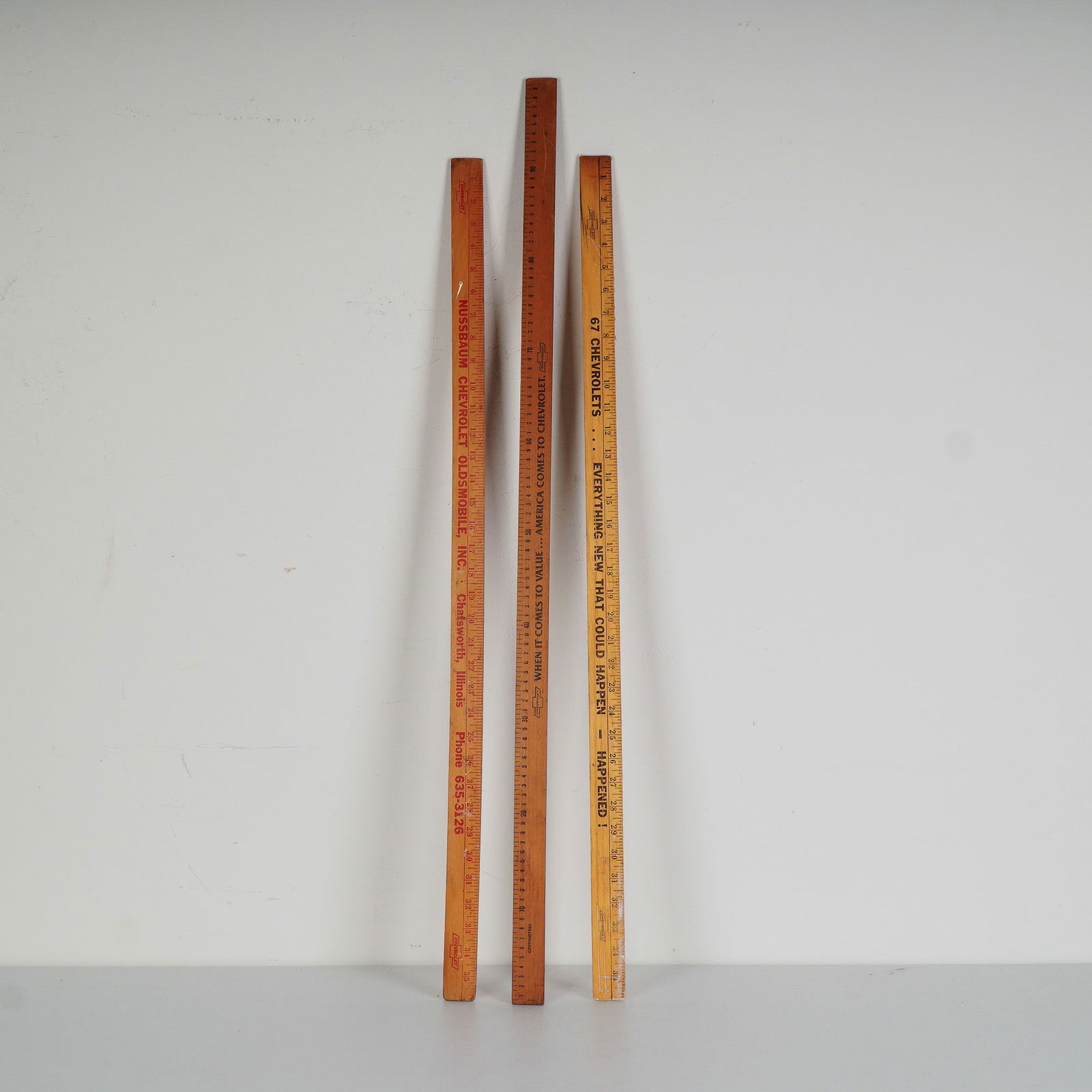 3pc Chevrolet Advertising Yardsticks: A set of three Chevrolet promotional wooden yardsticks, each featuring bold dealership advertising. These rulers are from mid-20th century American car dealers, with distinct typography and slogans th