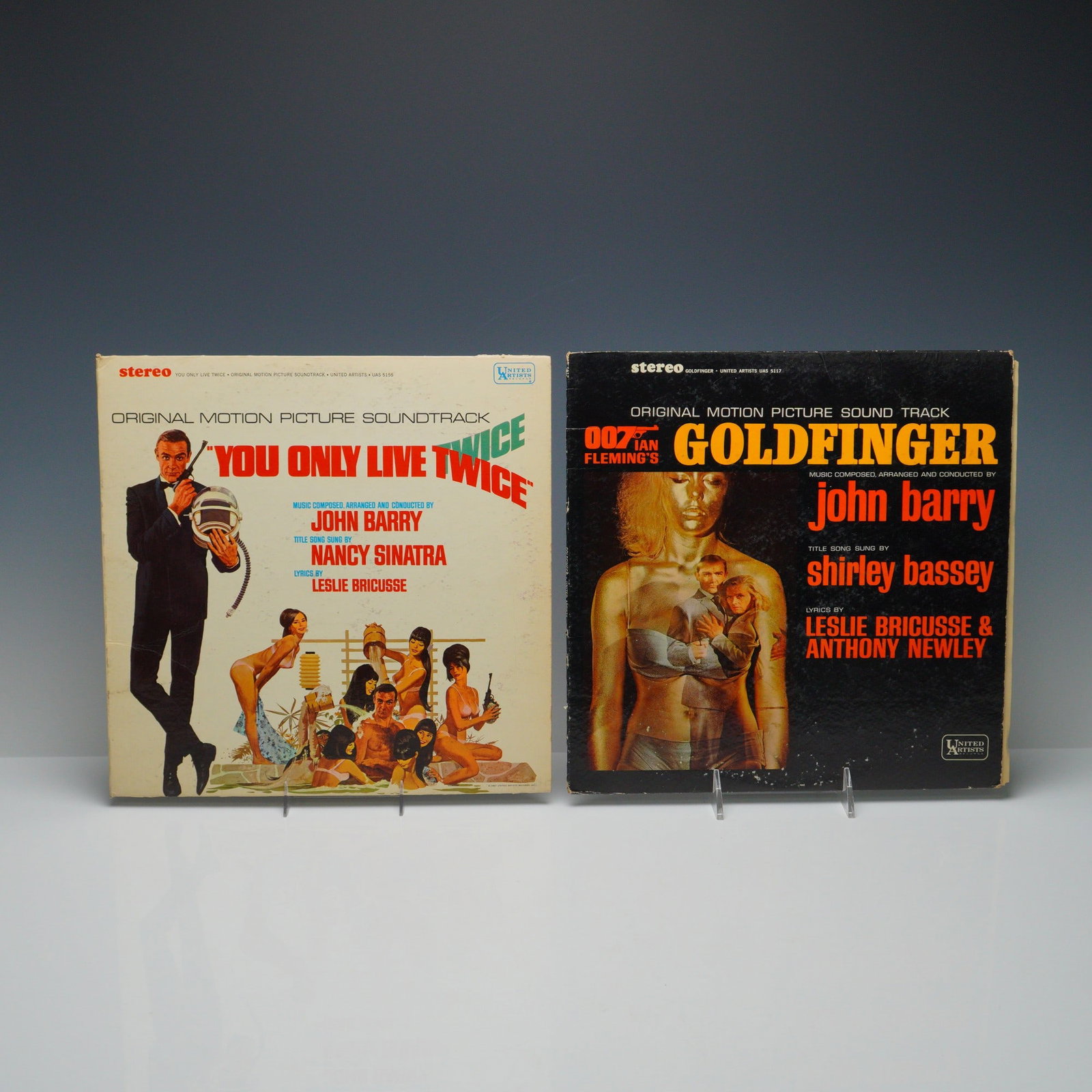 2pc James Bond Goldfinger & You Only Live Twice Record Grouping: This listing features a 2pc vinyl record grouping of James Bond soundtracks. Included are Goldfinger and You Only Live Twice, both from the iconic film series. Goldfinger features music composed by Jo