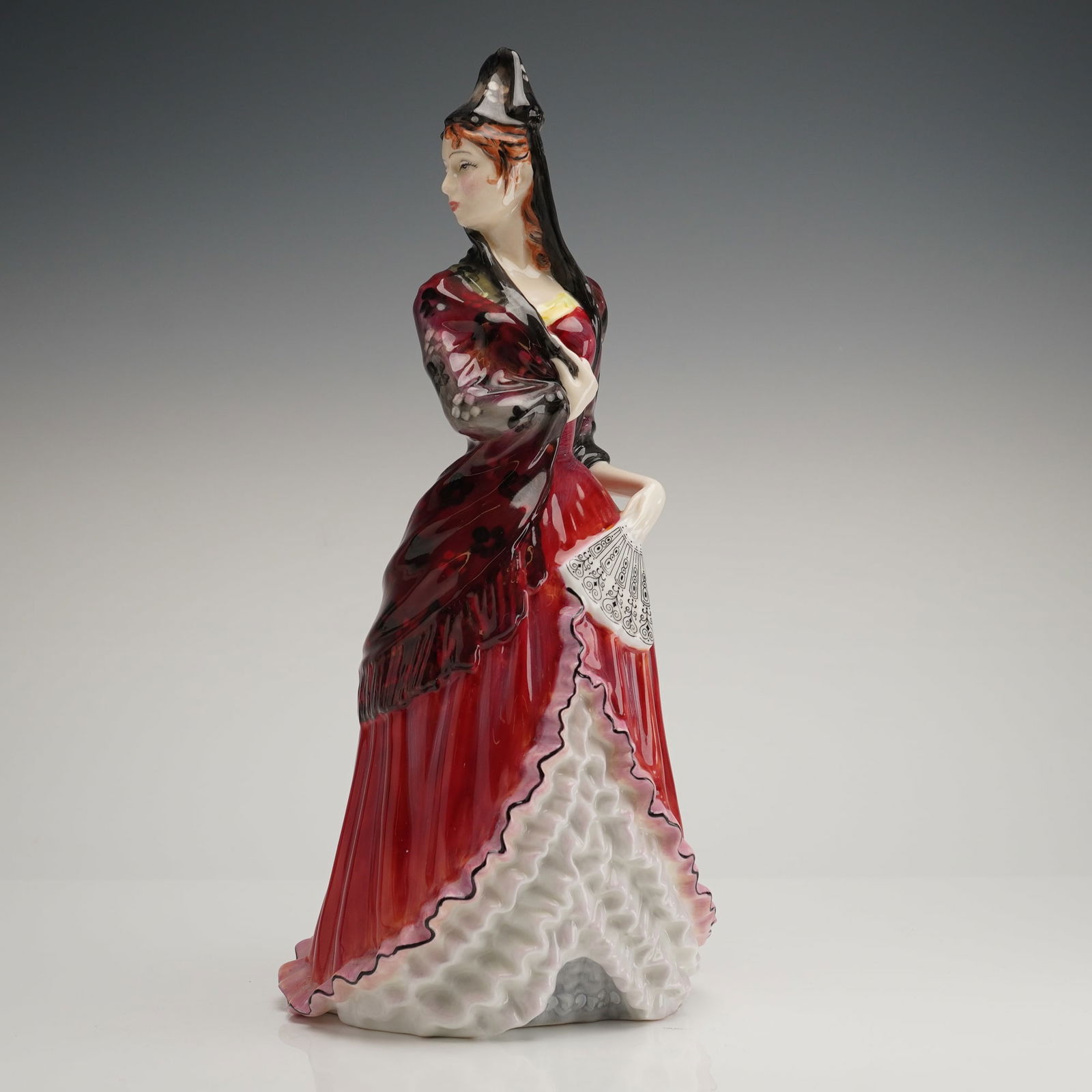 Royal Doulton Bone China Mantilla Figurine HN 2717: A single hand-painted glazed porcelain figurine identified as the Royal Doulton Bone China model Mantilla, HN 2717. The figurine depicts a standing female figure in traditional Spanish dress, featurin