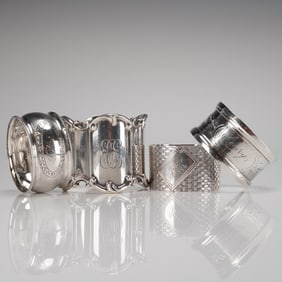 A Collection of Four Mixed Sterling Silver and Unmarked Napkin Rings