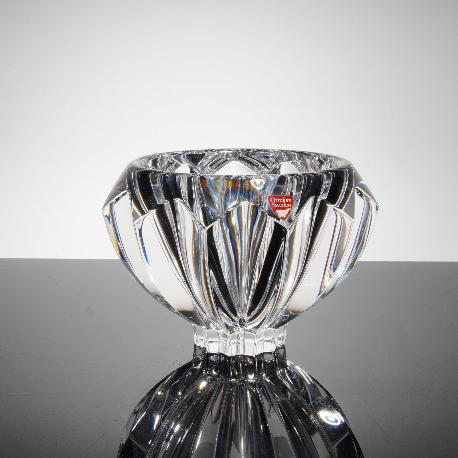 Orrefors Zodiac Crystal Bowl: A heavy, thick-walled centerpiece bowl executed in high-quality colorless crystal by Orrefors, Sweden. The form is widely known as the Zodiac patern, featuring deeply cut geometric, vertical faceting