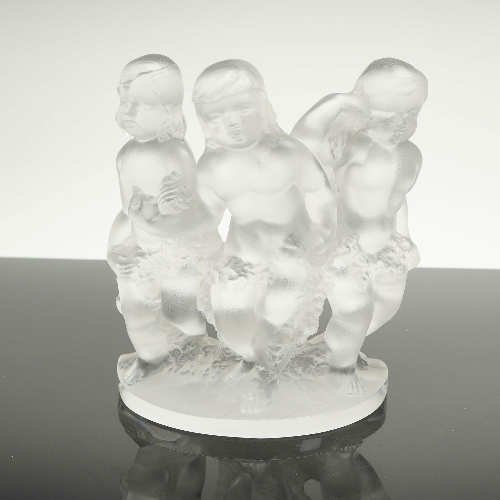 Lalique Crystal Frosted Luxembourg Cherub Bookend: A single Lalique Luxembourg crystal bookend. The sculpture is crafted from molded crystal glass, utilizing both clear and frosted (satin) finishes, characteristic of the Art Deco style. The compositio