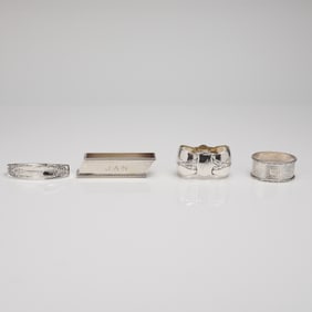 A Collection of Four Sterling and 800 Standard Silver Napkin Ring Holder