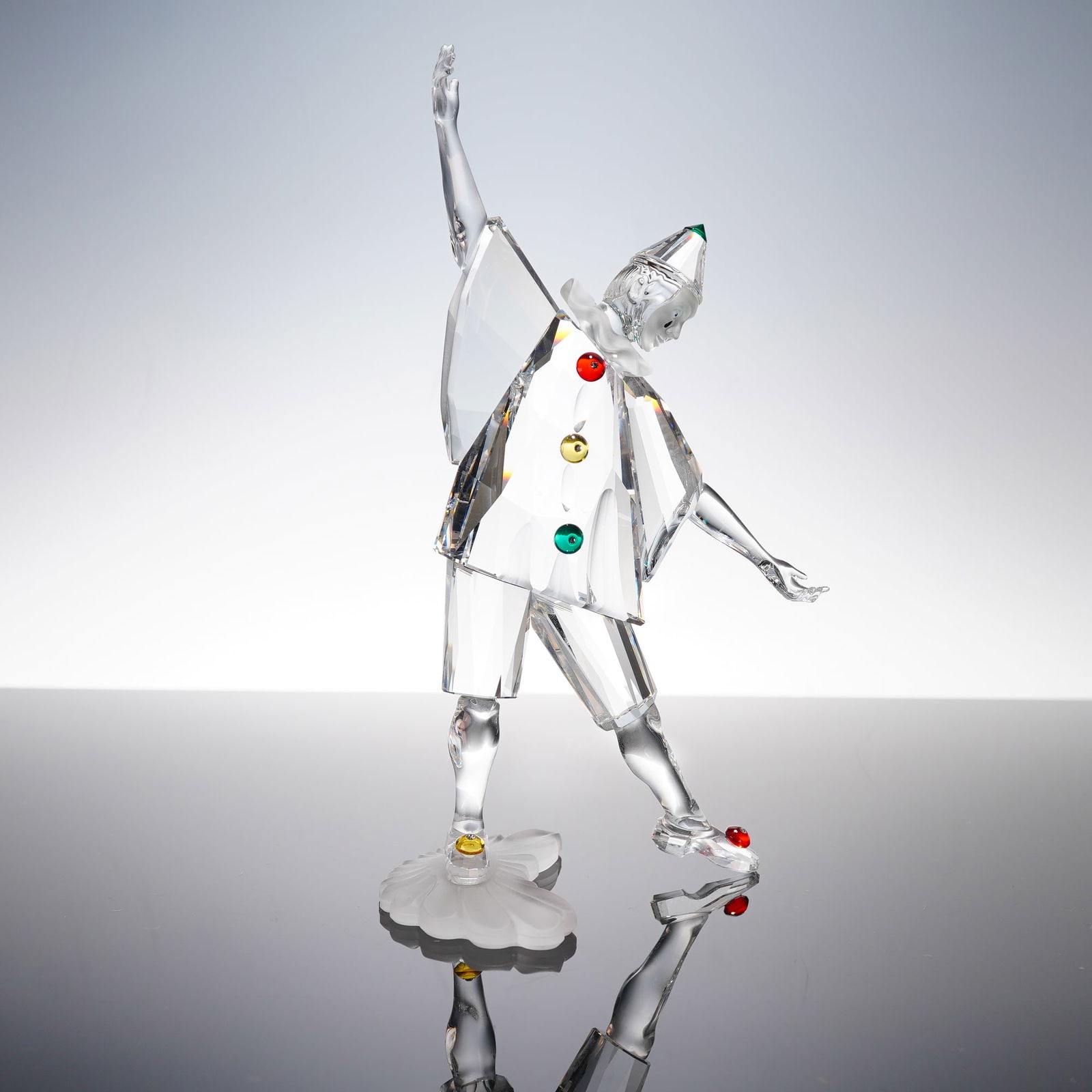 Swarovski SCS Annual Edition 1994 Crystal Figurine, Pierrot: A Swarovski SCS 1994 Annual Edition Pierrot figurine. Clear faceted crystal depicting a Pierrot/clown figure in expressive pose with red, yellow, and green crystal accents. Mounted on frosted crystal