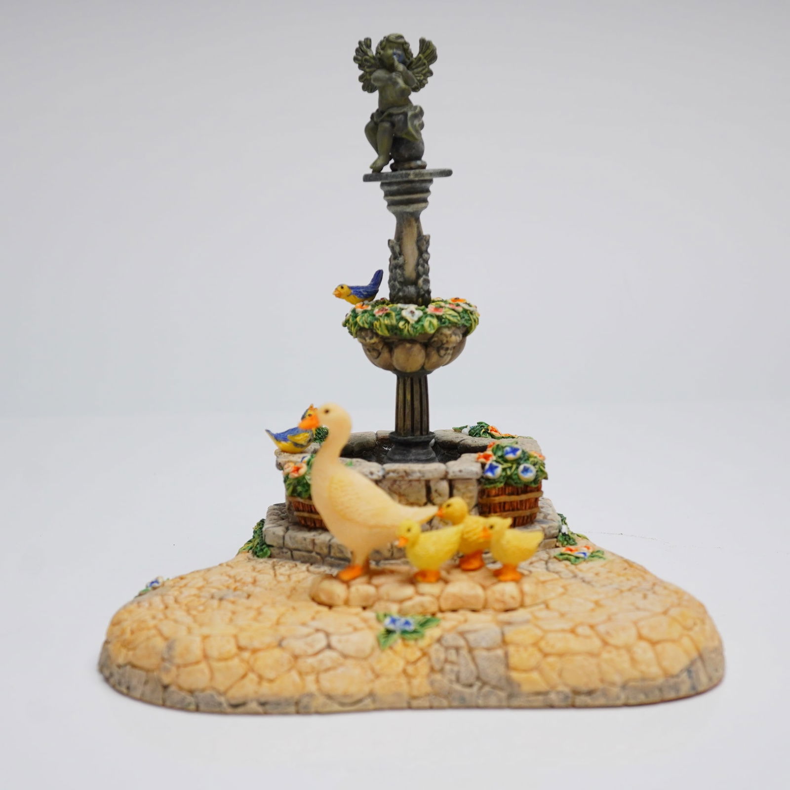 Goebel Fountain Square Figurine Mark 1049-D and Original Box: A Goebel collectible figurine titled "Fountain Square" (Mark # 1049-D) and its original plain cardboard storage box. The figurine is constructed of painted molded resin and depicts a miniature outdoor