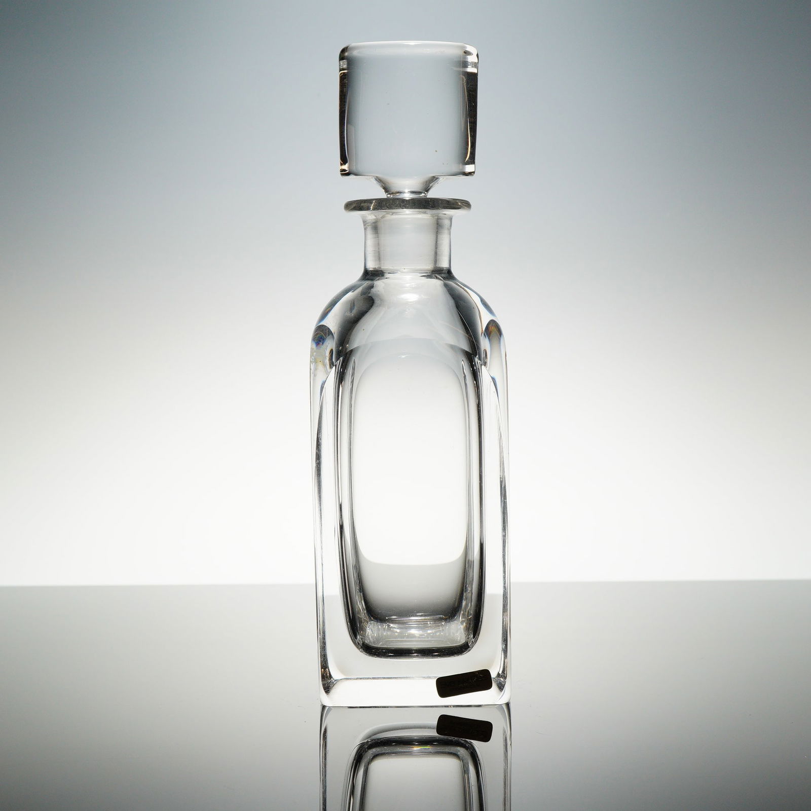 Orrefors Edward Hald Modernist Crystal Decanter with Stopper: A heavy, clear crystal liquor or spirits decanter designed by Edward Hald for Orrefors, Sweden. The decanter and its matching stopper feature a robust, squared, geometric body with thick walls, charac