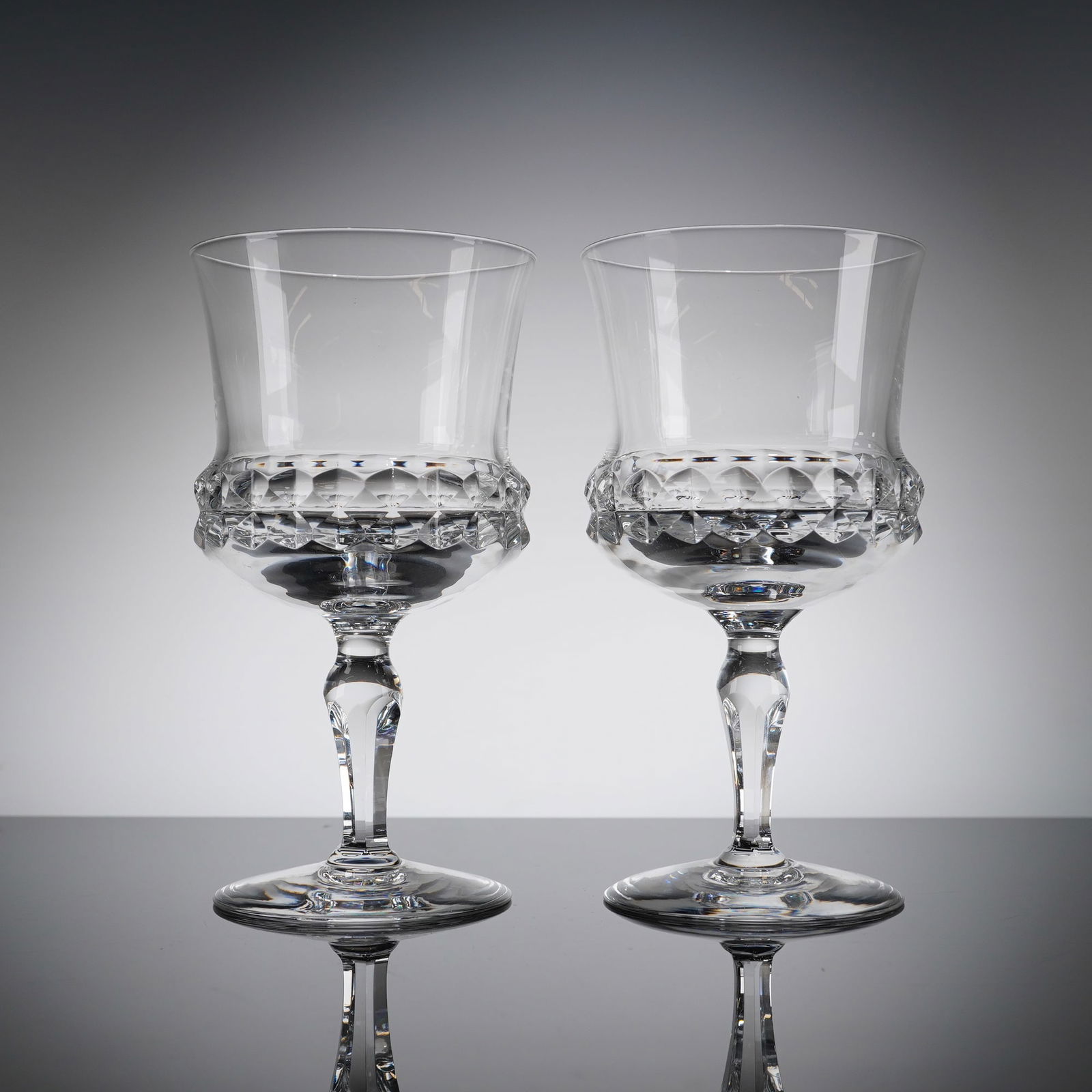 A Pair of Orrefors Crystal Silvia Water Goblets: A pair of Orrefors Swedish crystal water goblets in the 'Silvia' patern, designed by Ingeborg Lundin. These 2pc Orrefors Crystal water goblets feature a generous, slightly flared bowl crafted from cry