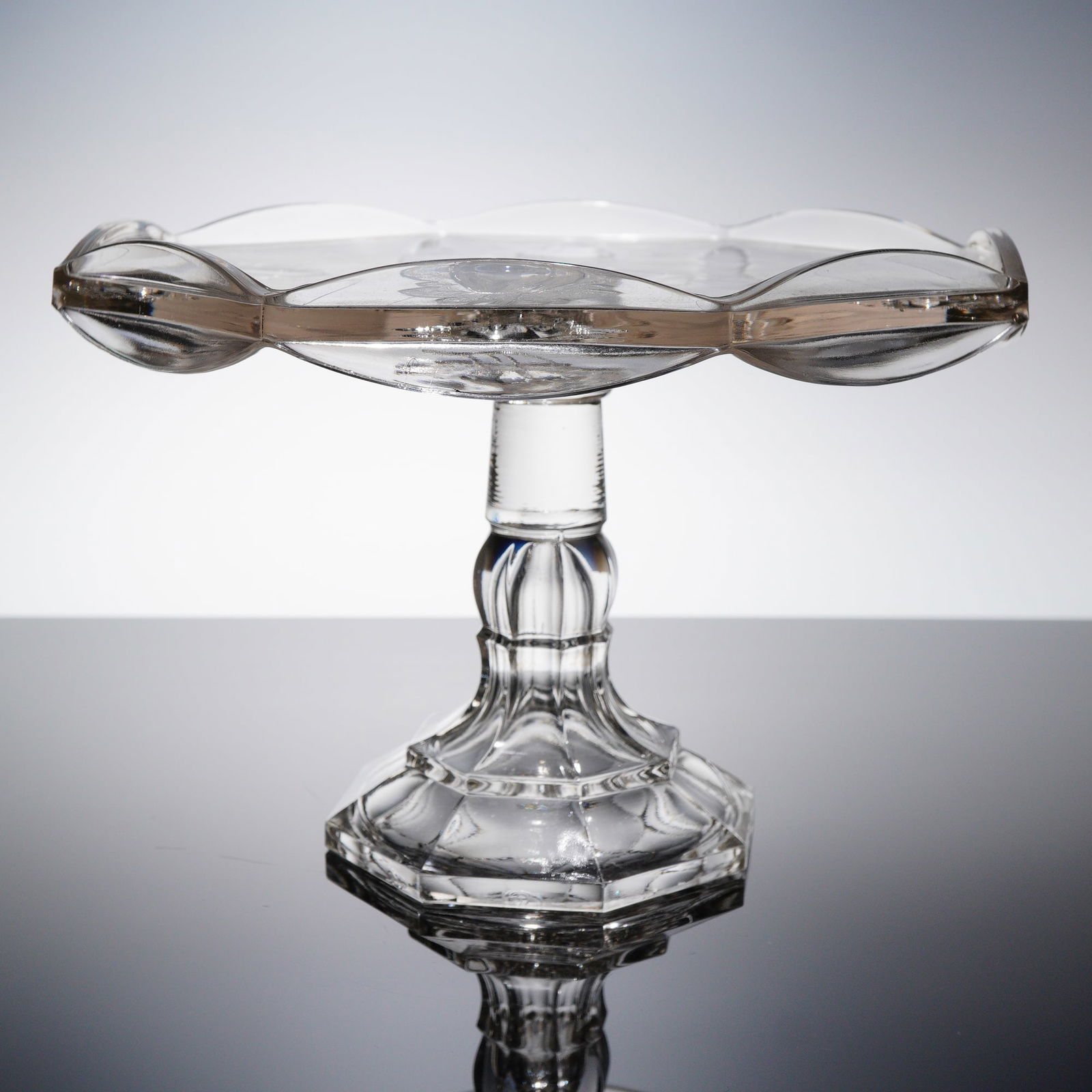 EAPG Adams & Co. Baltimore Pear Gipsy Pattern Pedestal Cake Stand: This is a single Early American Pattern Glass (EAPG) pedestal cake stand in the Baltimore Pear Gipsy pattern, attributed to Adams & Co. The object is constructed of clear, colorless pressed glass, typ