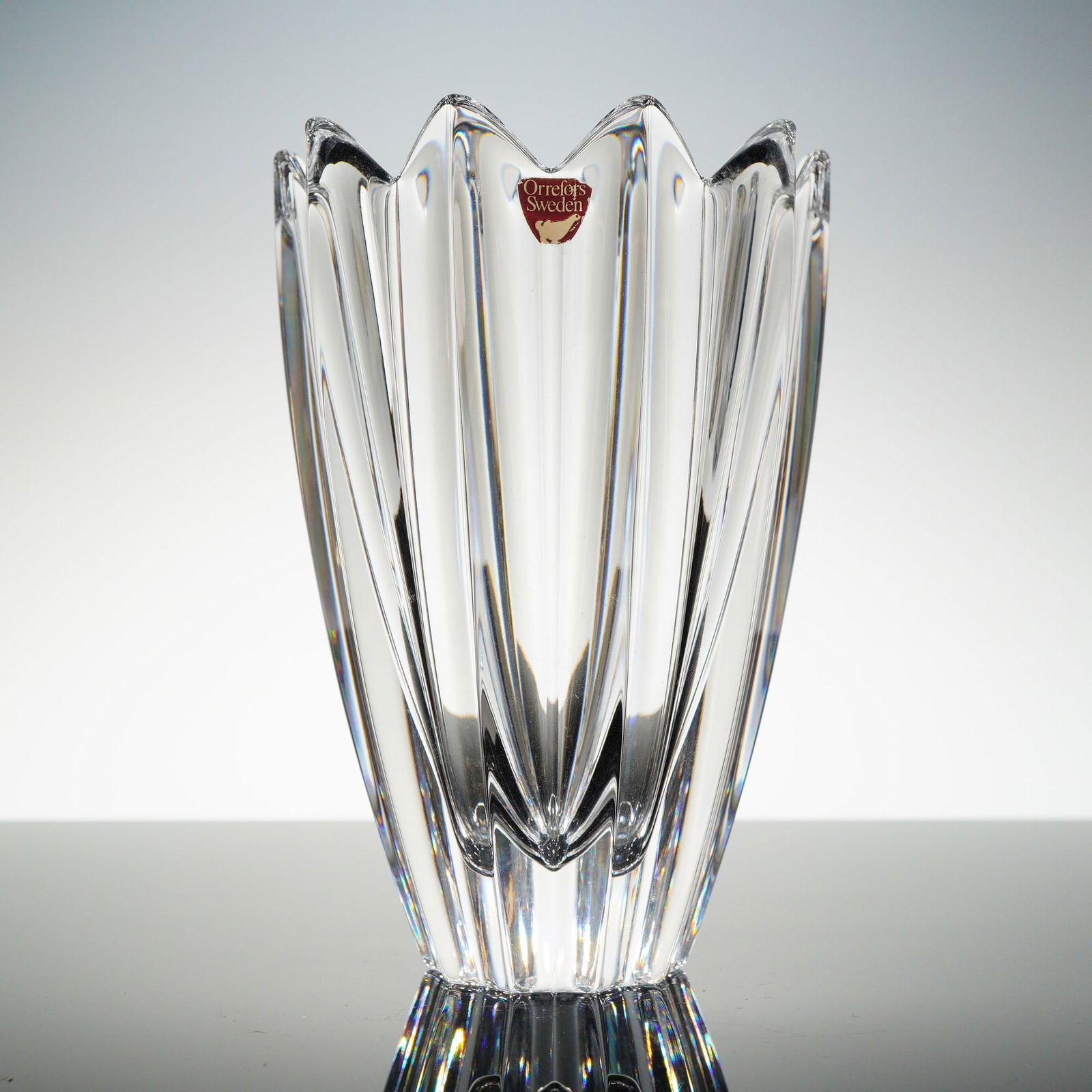 Orrefors Jan Johansson Fleur Crystal Vase: A single decorative vessel, identified through consensus as the "Fleur" design by Jan Johansson for Orrefors, Sweden. The object is crafted from clear, heavy crystal or high-quality glass. The body