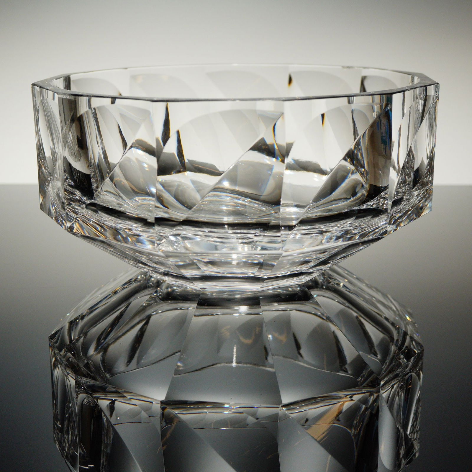 Orrefors Zenith Crystal Bowl Designed by Anne Nilsson: A single Orrefors Crystal Bowl in the Zenith patern, designed by Anne Nilsson. This heavy clear crystal vessel features a shallow dish form with an octagonal rim and a multifaceted, tapering body.