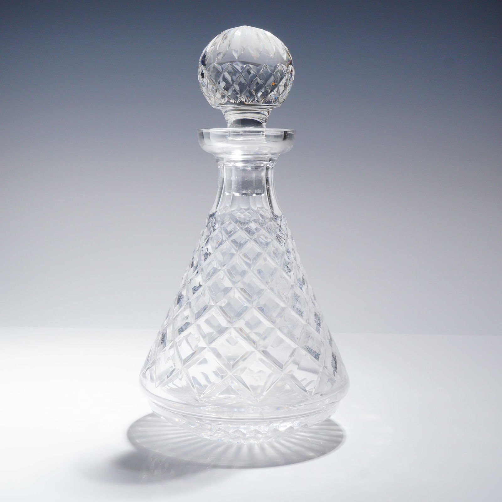 Waterford Crystal Decanter with Stopper, Alana: This Waterford crystal Alana decanter with stopper, crafted in Ireland, showcases Waterford's signature quality and craftsmanship. Featuring the signature diamond and wedges cuts, the decanter has a f