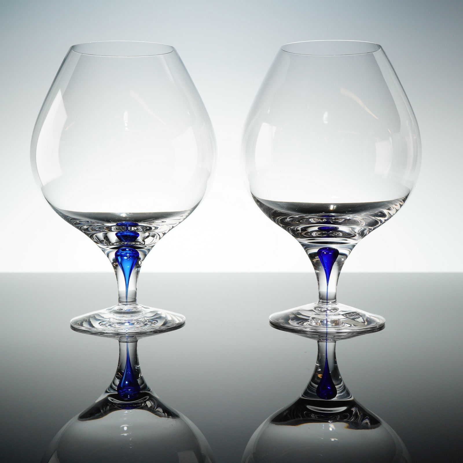 A Pair of Orrefors Intermezzo Blue Crystal Brandy Sniffeers (1 of 3)