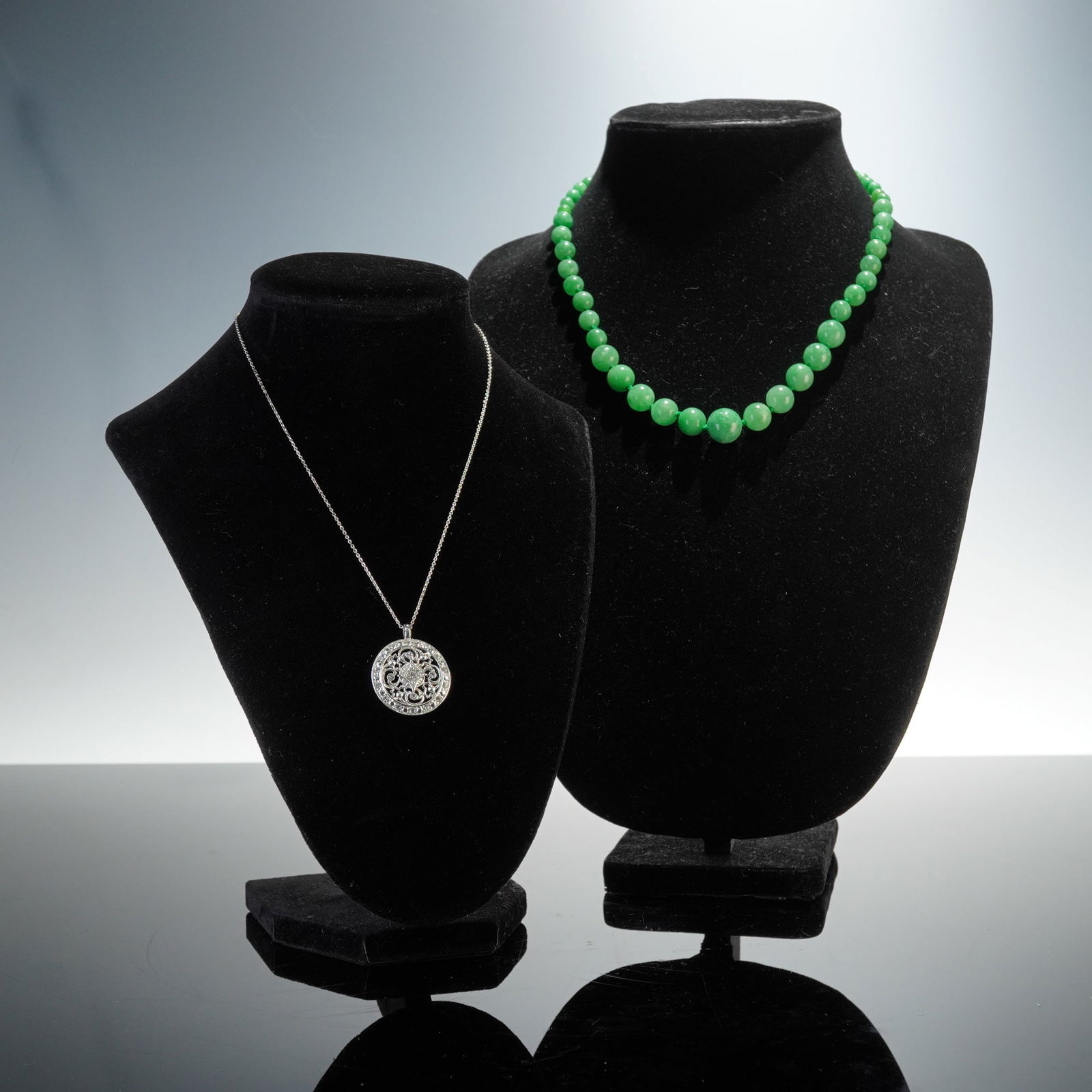 2pc Green Bead Necklace and Silver Tone Pendant Necklace Set: This set includes two elegant pieces: a green bead necklace featuring smooth, polished green beads individually knotted for a classic look, and a silver tone pendant necklace with an intricate