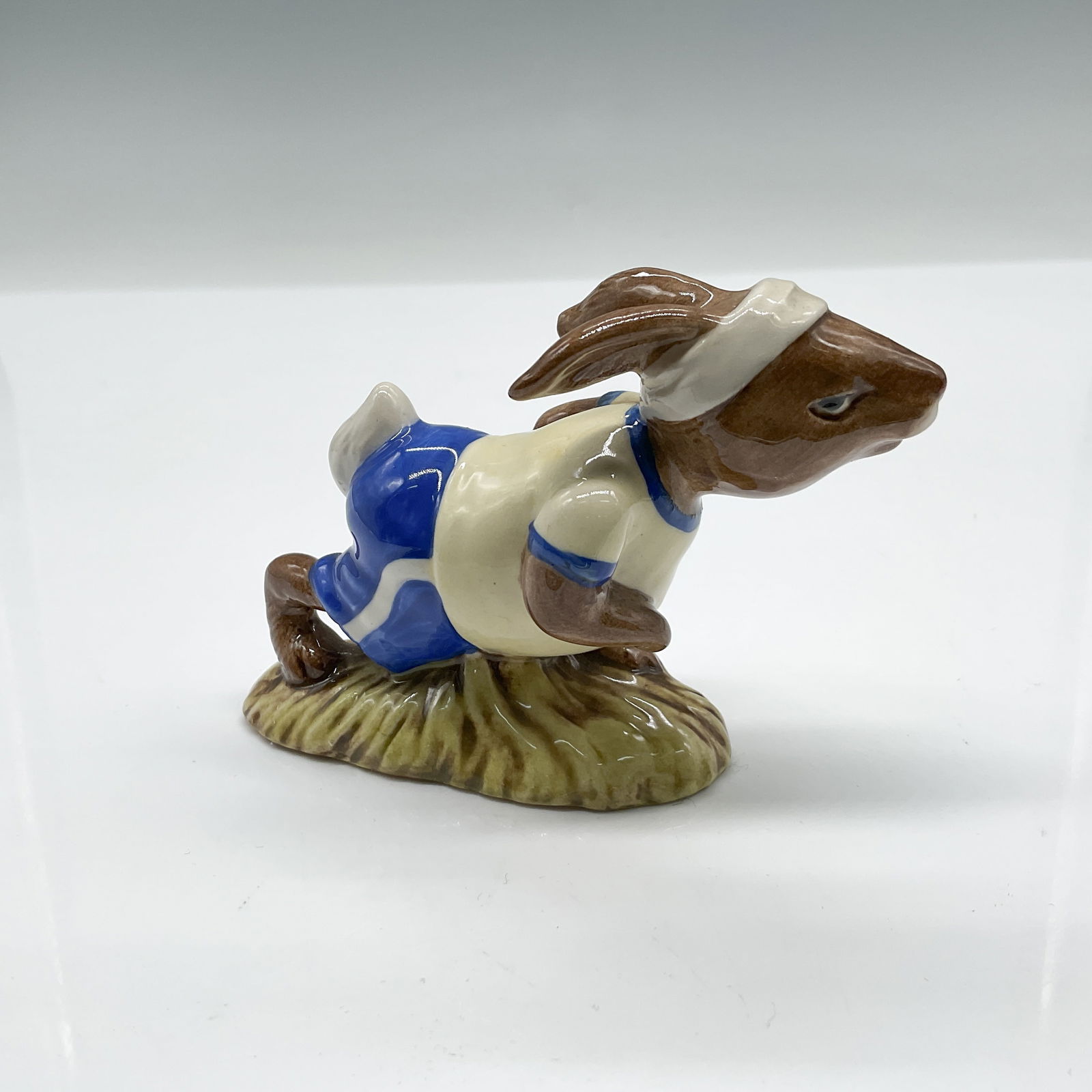 Royal Doulton Bunnykins Jogging Figurine DB228: This is a delightful Royal Doulton Bunnykins figurine titled Jogging Bunnykins, model number DB228, released in 1982. Crafted with exquisite attention to detail, this hand-painted porcelain figurine d