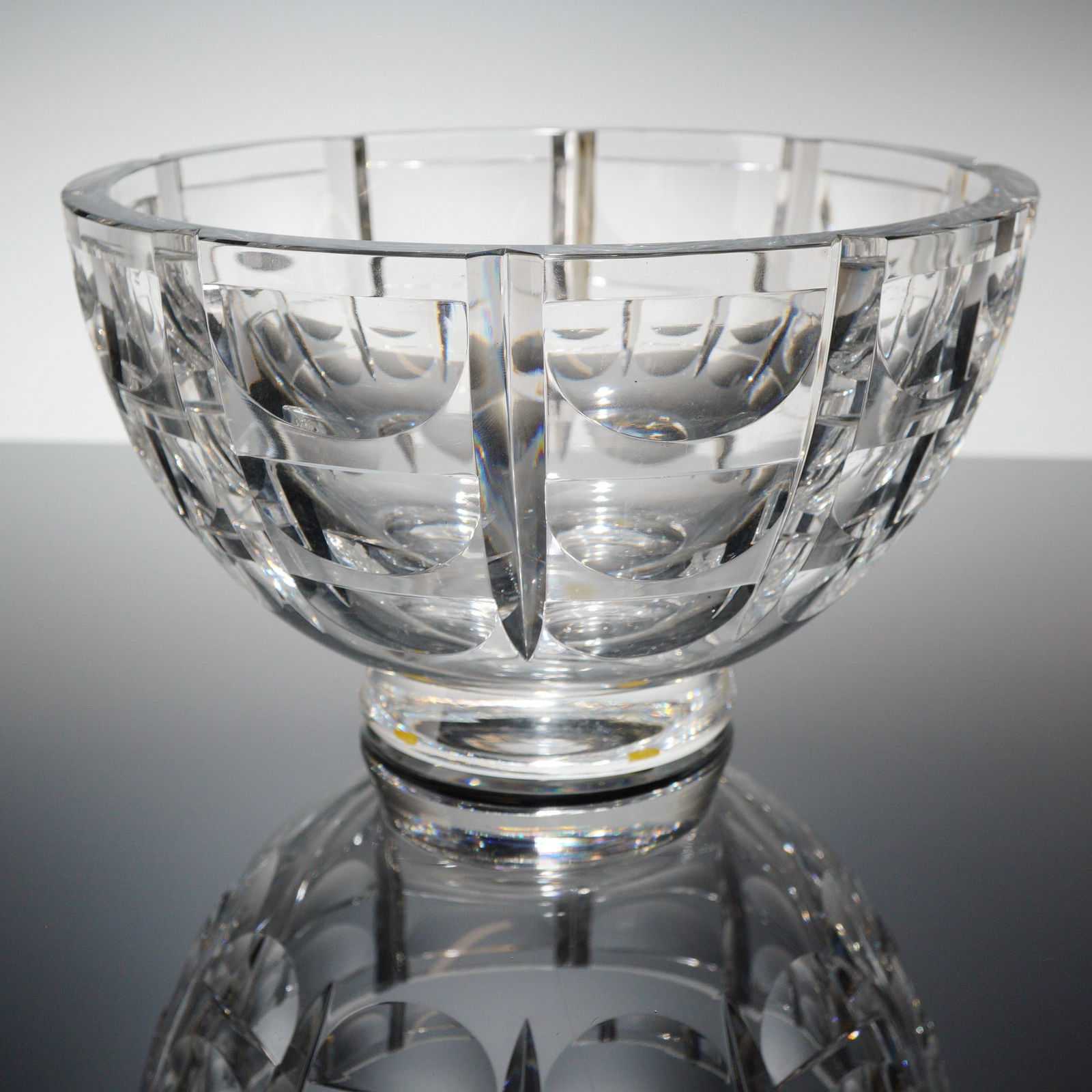 Orrefors by Simon Gate Thousand Windows Crystal Centerpiece Bowl: A vintage Orrefors Crystal centerpiece bowl in the "Thousand Windows" patern, designed by Simon Gate. This heavy footed bowl is composed of clear cut crystal, exhibiting a modern, geometric