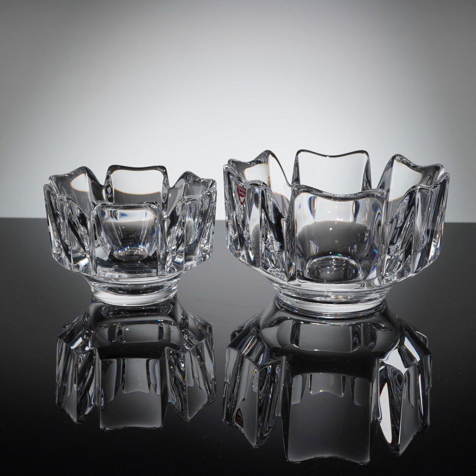 Two Orrefors Crystal Corona Bowls: Corona bowls with paneled crystal sides on footed base. Orrefors etched mark on base of both. Dimensions: 5.50"W x 3.75"H