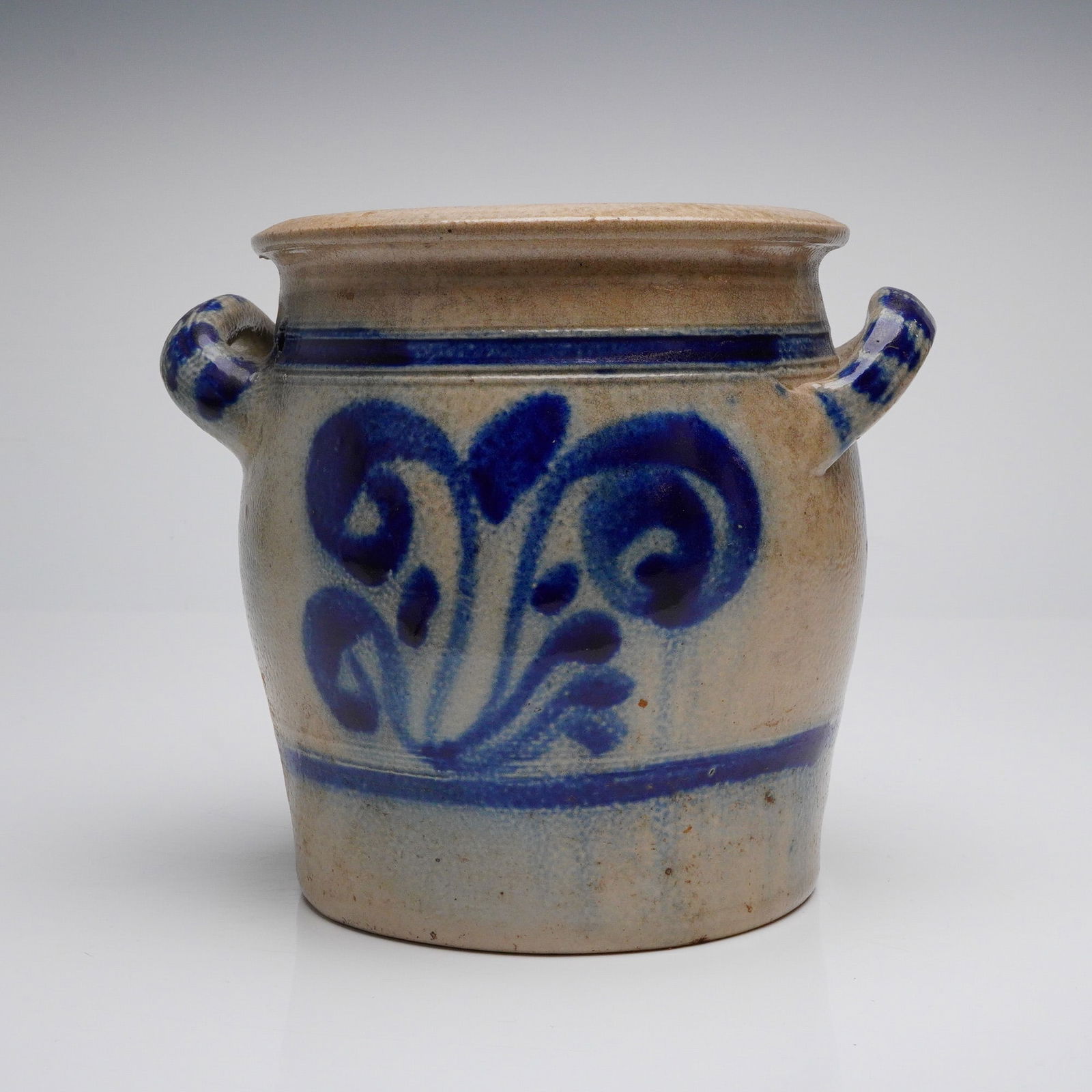 Antique Westerwald Salt-Glazed Stoneware Handled Crock: A single Westerwald-style salt-glazed stoneware handled crock, consistent with 19th-century German production. This robust, cylindrical storage jar, sometimes referred to as a salt-glazed earthenware