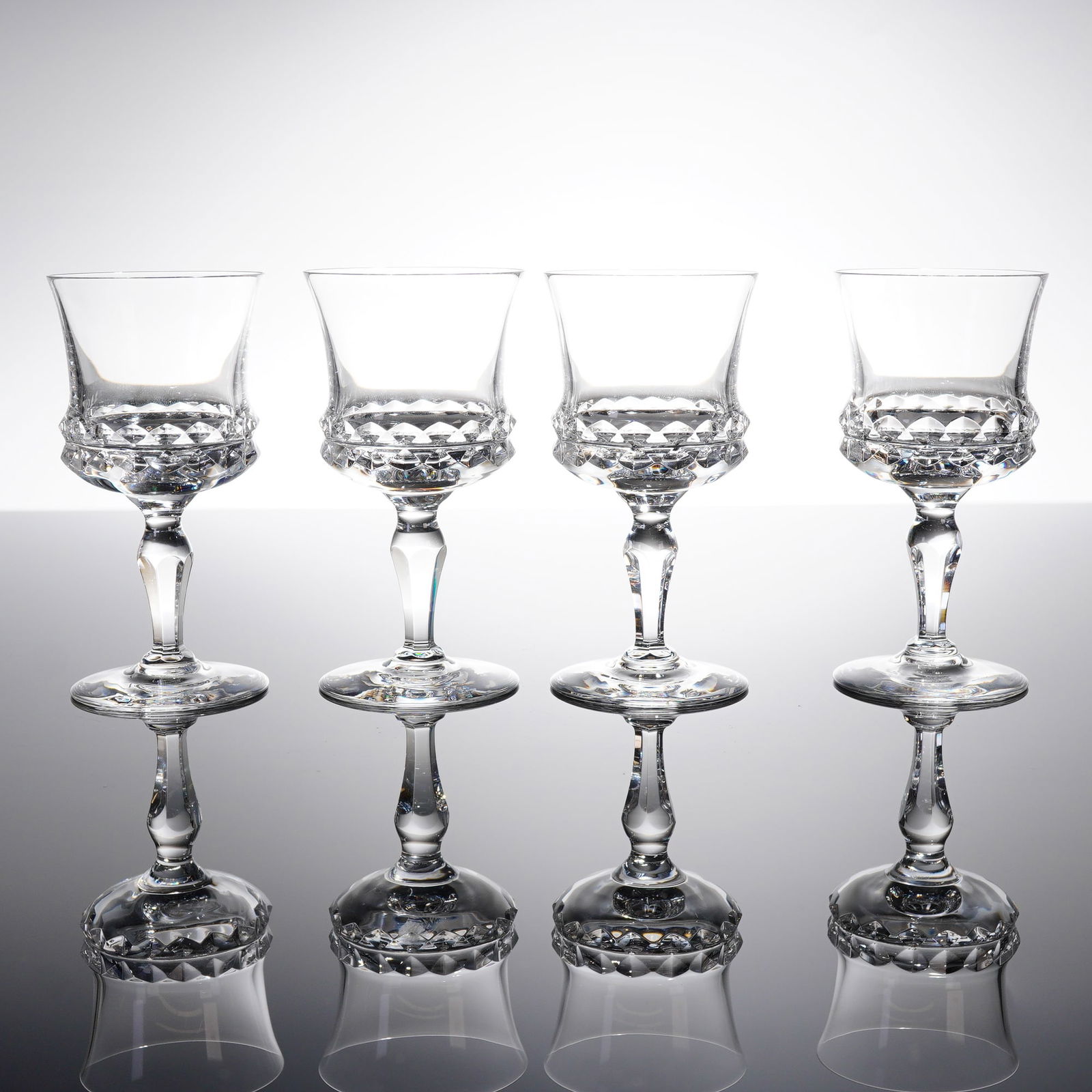 Collection of Four Orrefors Silvia Crystal Sherry Glasses: A collection of four lead crystal stemmed glasses in the 'Silvia' patern by Orrefors, Sweden. These items are identified as Sherry glasses. Each glass features a tapering bowl that fi?ares slightly at