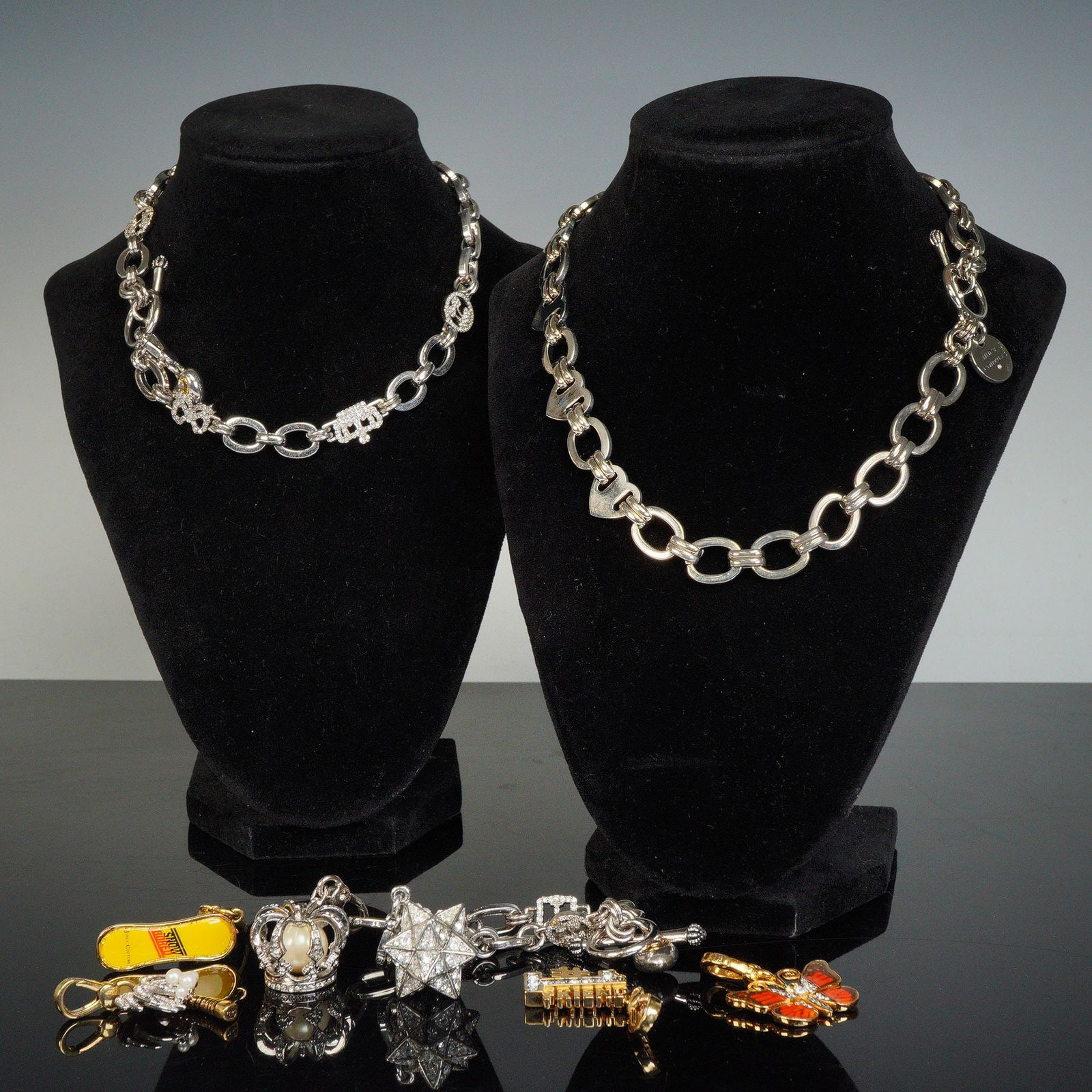 7pc Juicy Couture Jewelry- Necklaces, Bracelet and Charms: Stylish jewelry collection including two link necklaces, one charm bracelet, and four assorted charms. The set features signature Juicy Couture motifs in silver-tone and gold-tone finishes, including