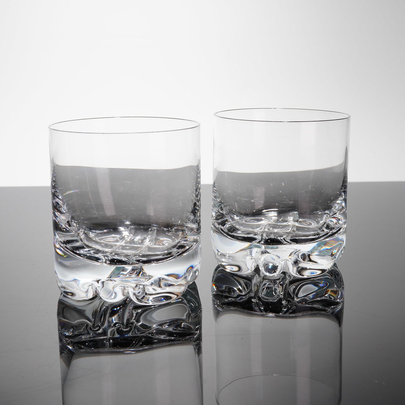 A Pair of Orrefors Intermezzo Double Old Fashioned Glasses: A pair of heavy clear crystal glasses in the Erik patern, manufactured by Orrefors of Sweden. These glasses are designed in the Double Old Fashioned (DOF) or Rocks style, featuring a cylindrical body