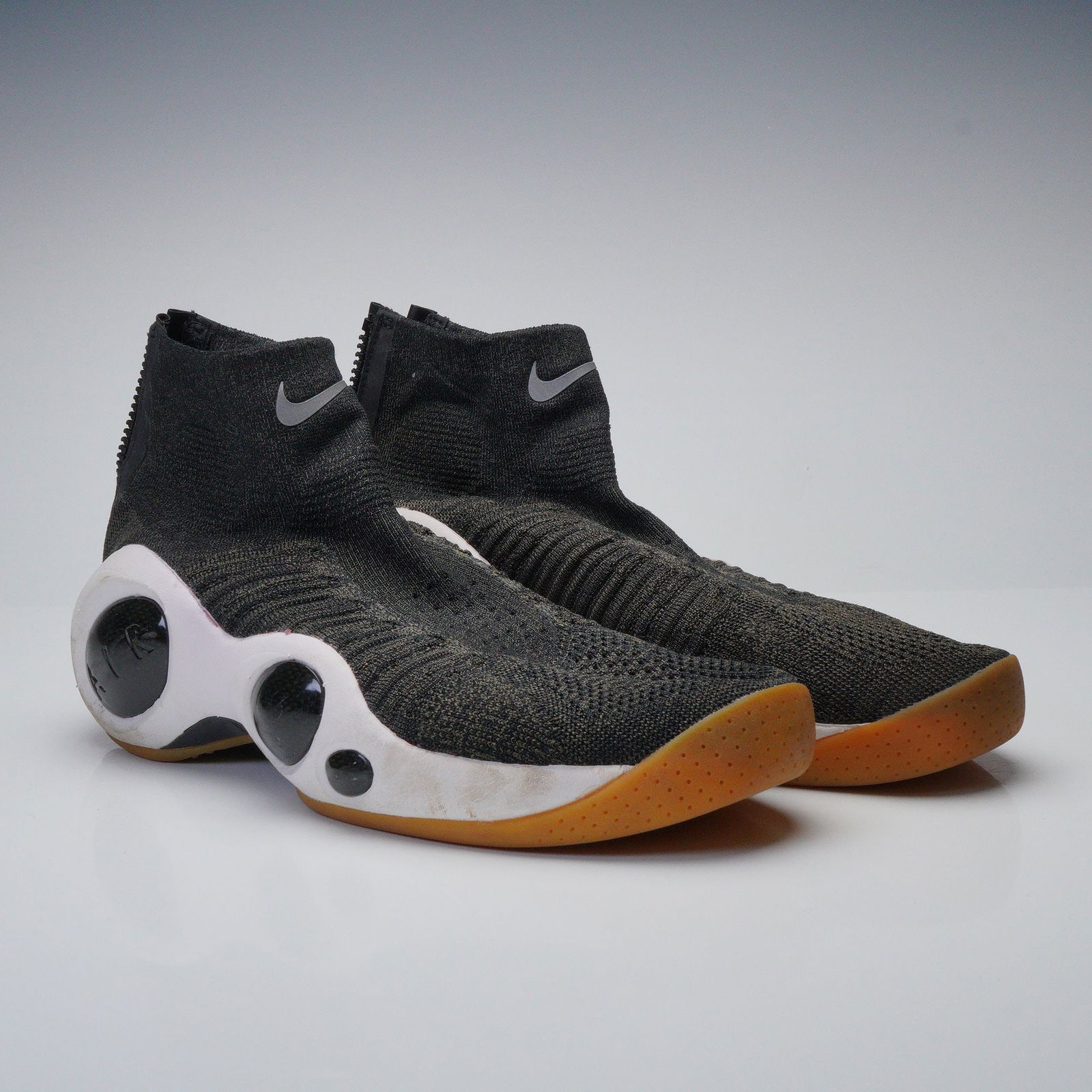 A Pair of Nike Flight Bonafide Black Athletic Shoes: A pair of Nike Flight Bonafide Black athletic shoes. These modern, high-top athletic shoes feature a dark grey/black knitted textile upper with a sock-like ankle collar secured by a black rear