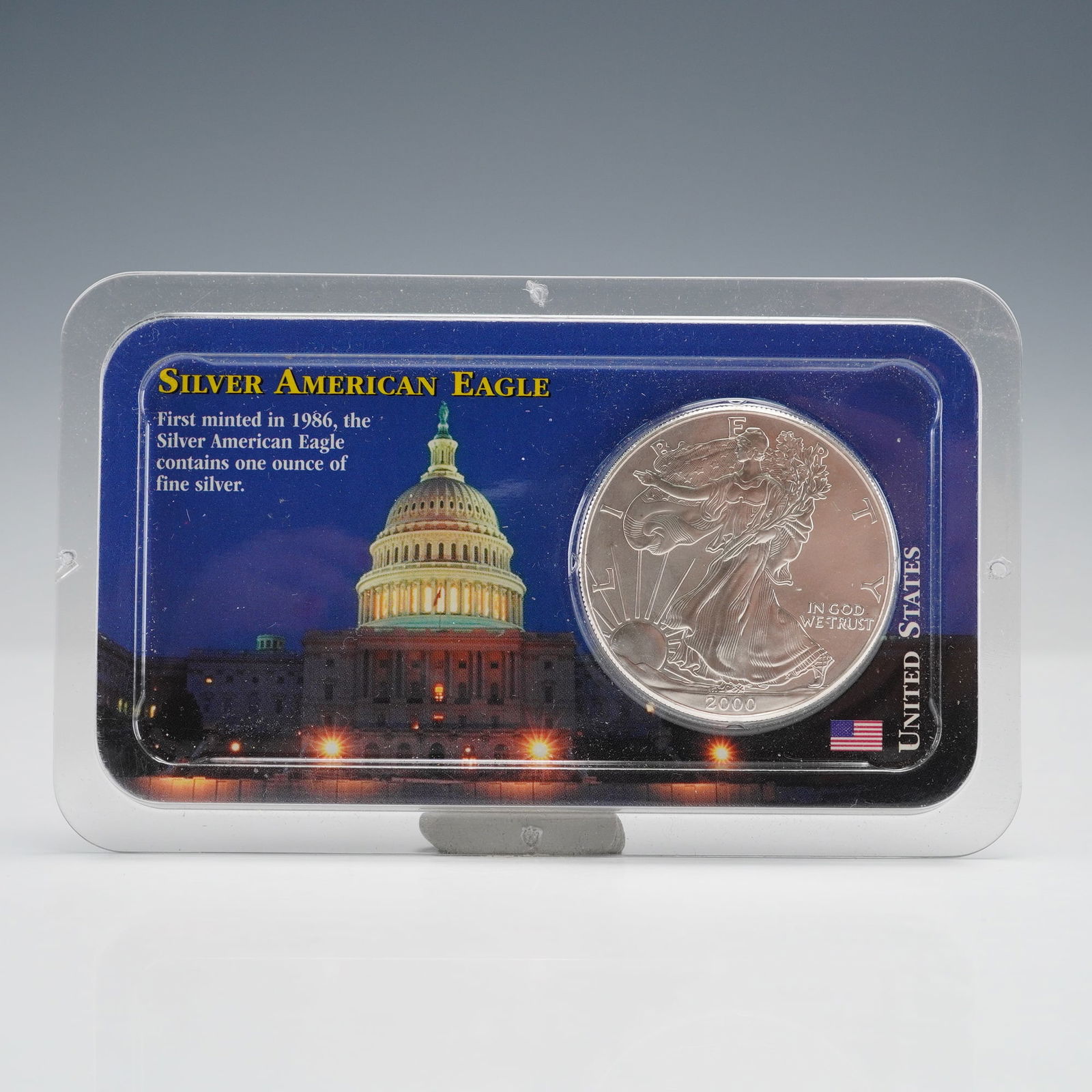 2000 American Silver Eagle 1 oz .999 Fine Silver: A 2000 American Silver Eagle 1 oz .999 fine silver coin in original Littleton sealed holder. Obverse: Walking Liberty, LIBERTY, 2000, IN GOD WE TRUST. Reverse: Heraldic Eagle, UNITED STATES OF