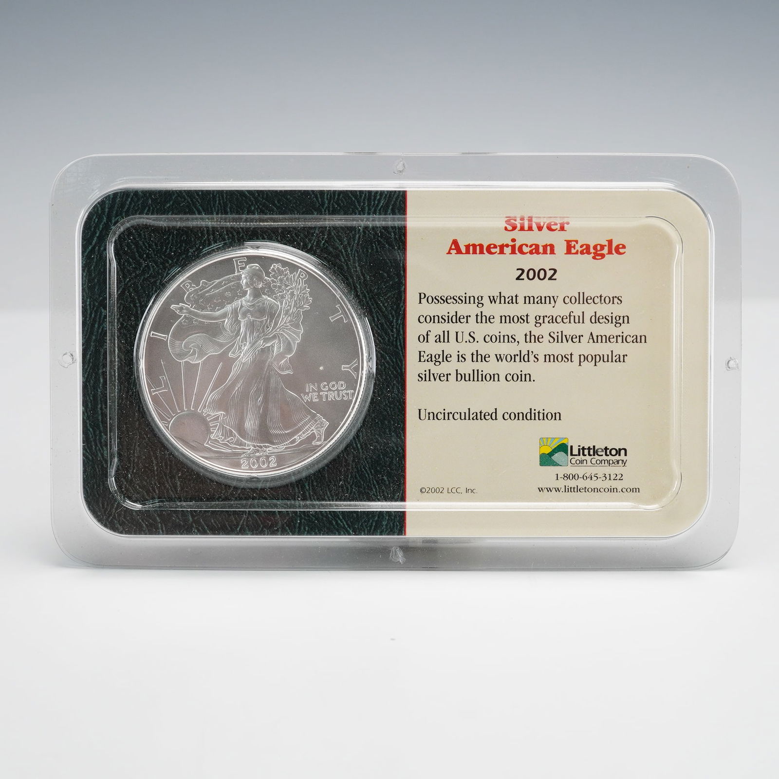 2002 American Silver Eagle 1 oz in Littleton Silverpak: A 2002 American Silver Eagle 1 oz coin in original Littleton Silverpak display case. Obverse: Liberty Walking, LIBERTY, IN GOD WE TRUST, 2002. Reverse: Heraldic Eagle, UNITED STATES OF AMERICA, 1 OZ.