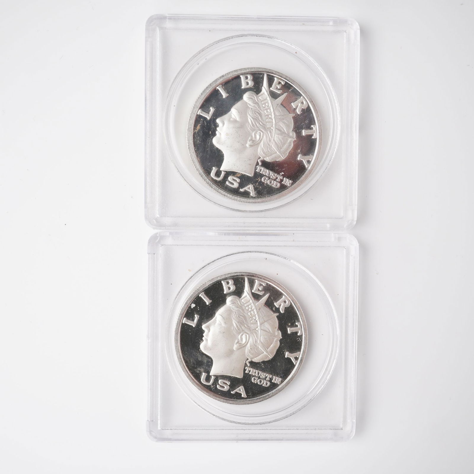 2pc 2003 1/2 Troy Ounce Five Dollar Silver Rounds: Two 2003 Liberty Dollar silver rounds, each struck in .999 fine silver with a face denomination of $5. Displaying on the obverse a left-facing portrait of Liberty wearing a crown, surrounded by