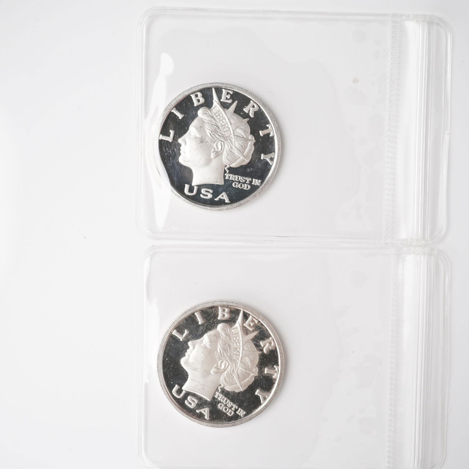 2pc 2003 1/2 Troy Ounce Five Dollar Silver Rounds: Two Liberty Dollar silver rounds, each struck in .999 fine silver with a denomination of five dollars. The obverse depicts a left-facing bust of Liberty wearing a diadem, accompanied by inscriptions