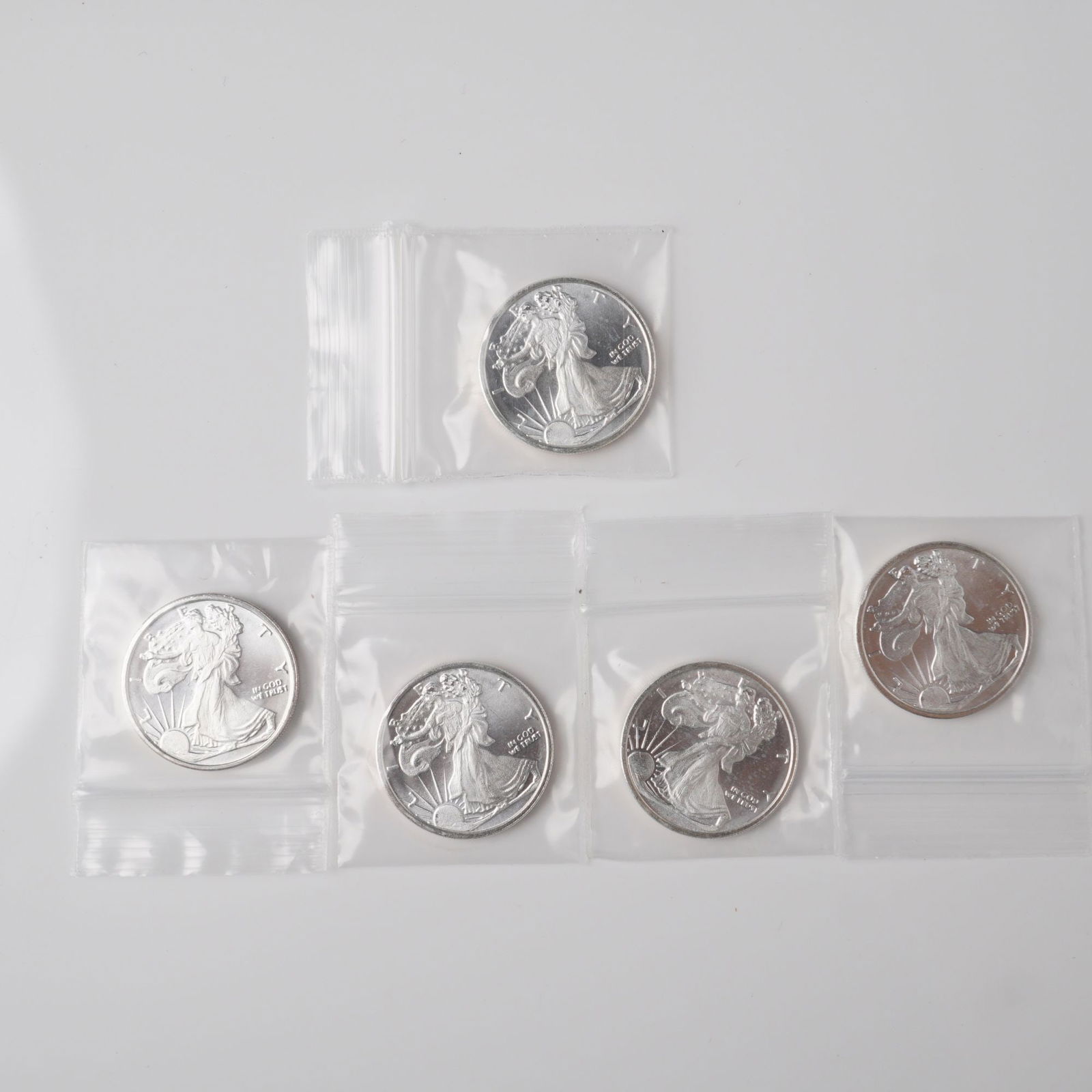 5pc Highland Mint Walking Liberty 1/4 oz Silver Rounds: This lot includes five 1/4 oz silver rounds. The obverse features the iconic Walking Liberty design by Adolph A. Weinman, with the inscriptions LIBERTY and IN GOD WE TRUST. The reverse displays a