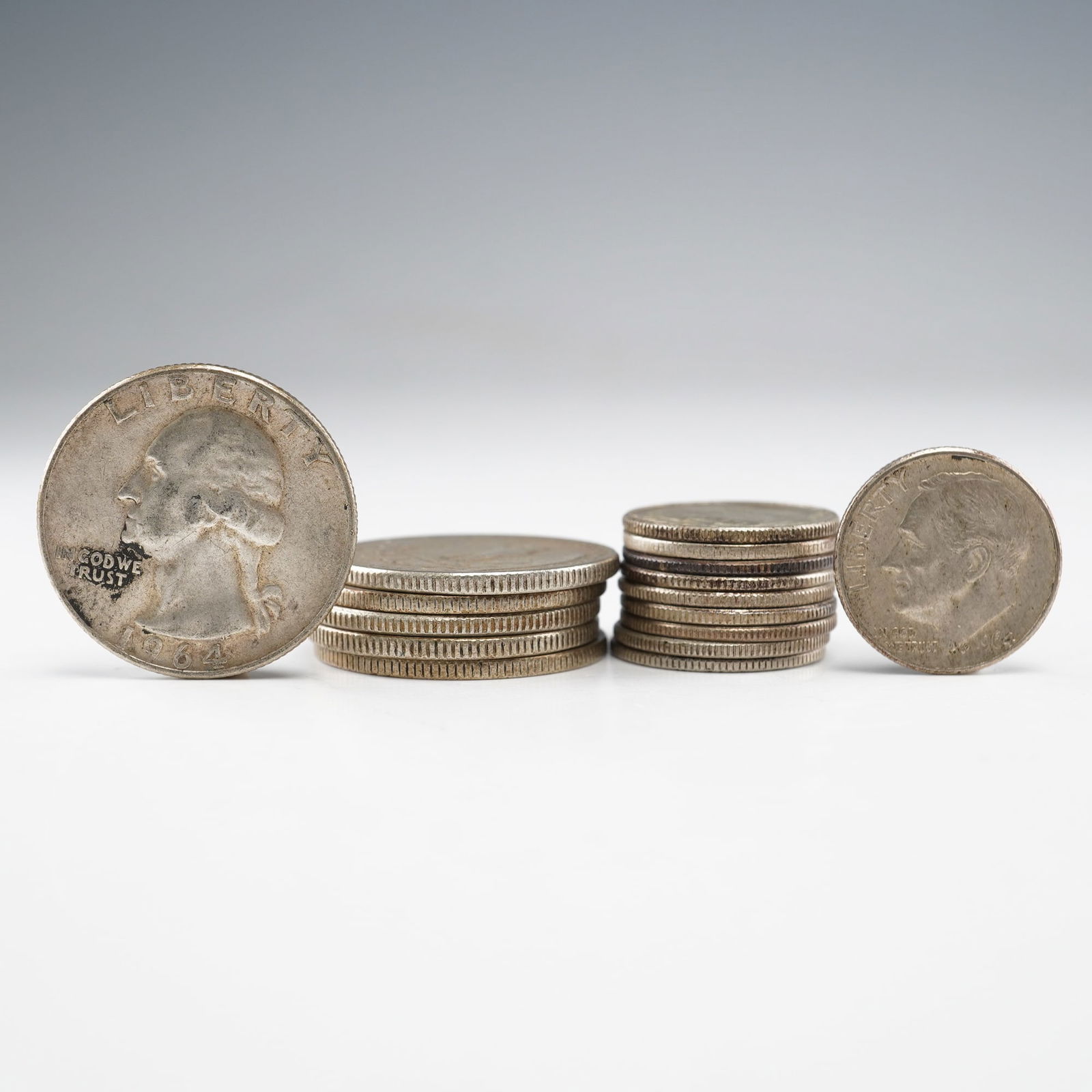 16pc US Silver Dimes and Quarters, 1940s and 1960s: Sixteen U.S. silver coins: ten Roosevelt dimes (1946, 1960, 1962, 1964 x7) and six Washington quarters (1943, 1953, 1959, 1961, 1964 x2). All 90% silver. Weight for all 16 coins. Dimensions: 0.94"