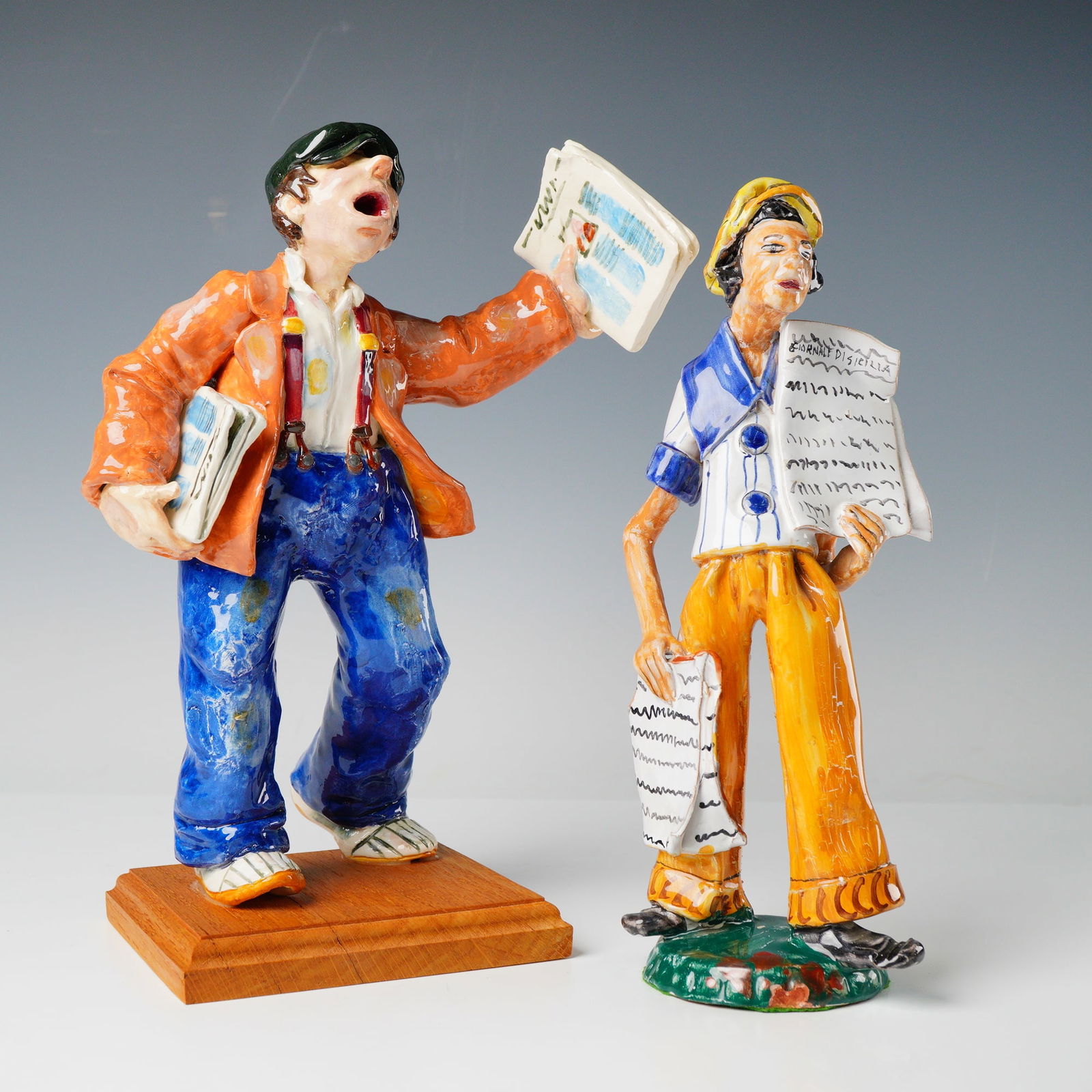 A Pair of Ceramic Newsboy Figurines (1 of 4)